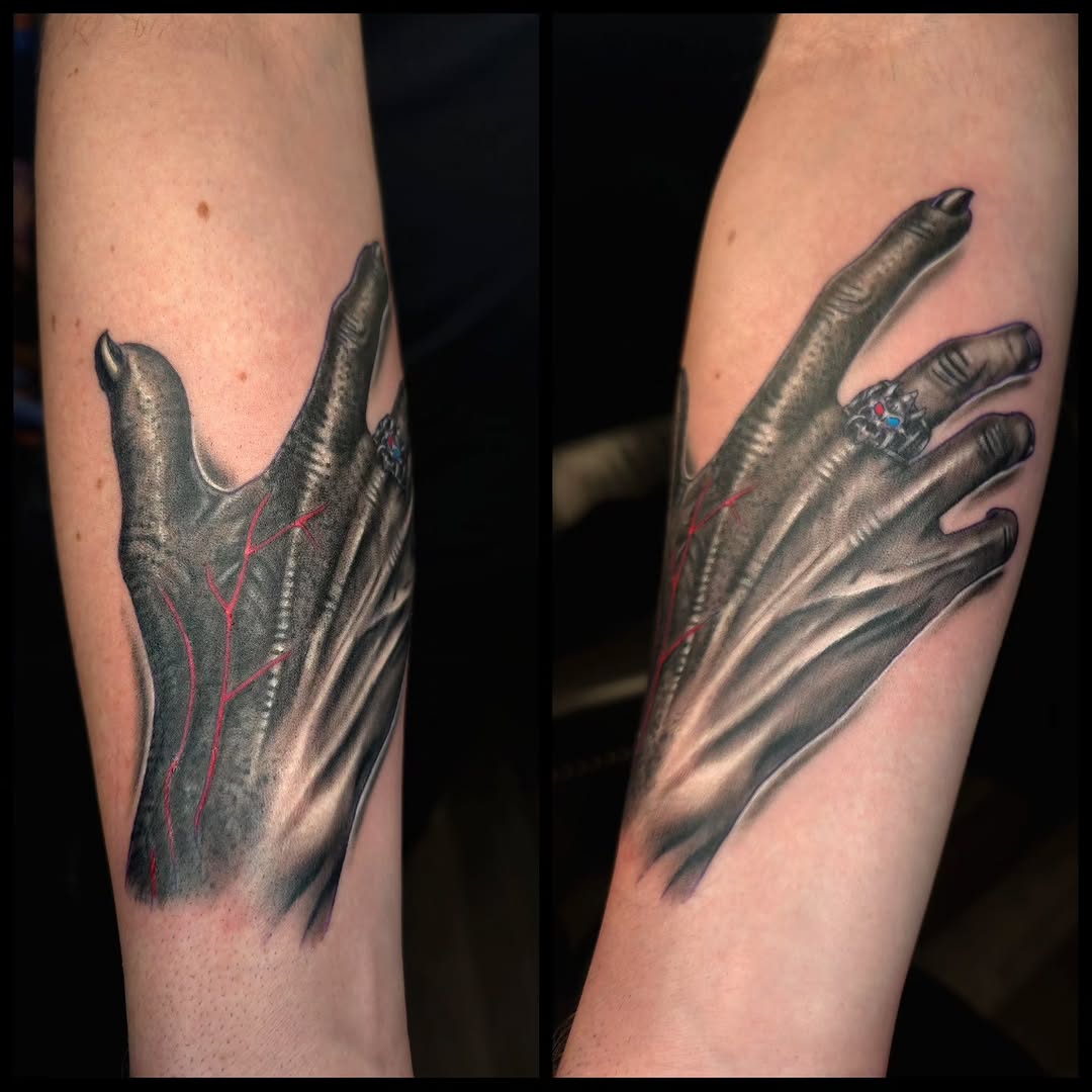 Alien hand with ring realism tattoo on the forearm by Ian Duncanson