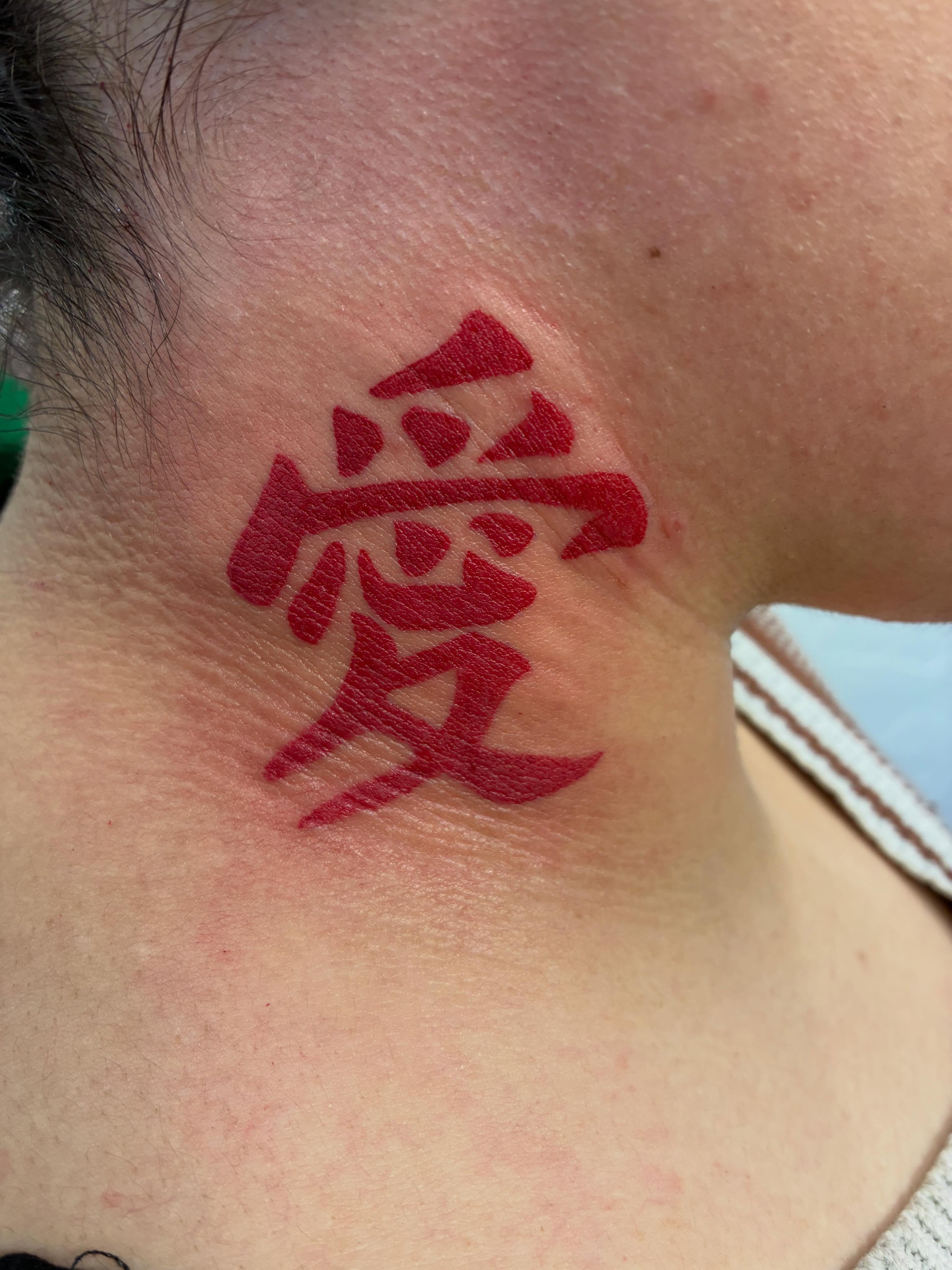 Kanji character lettering script tattoo on the neck by James Ostler