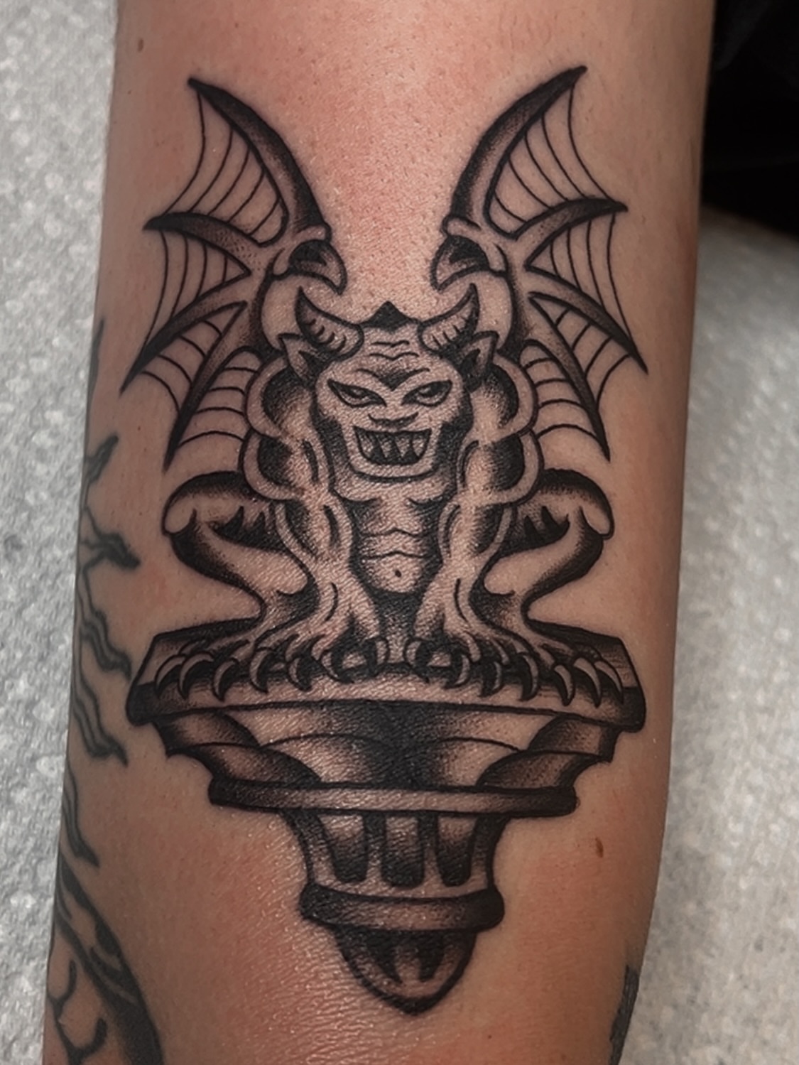 Demon head black and grey tattoo on the forearm by Las Vegas Tattoo Artist