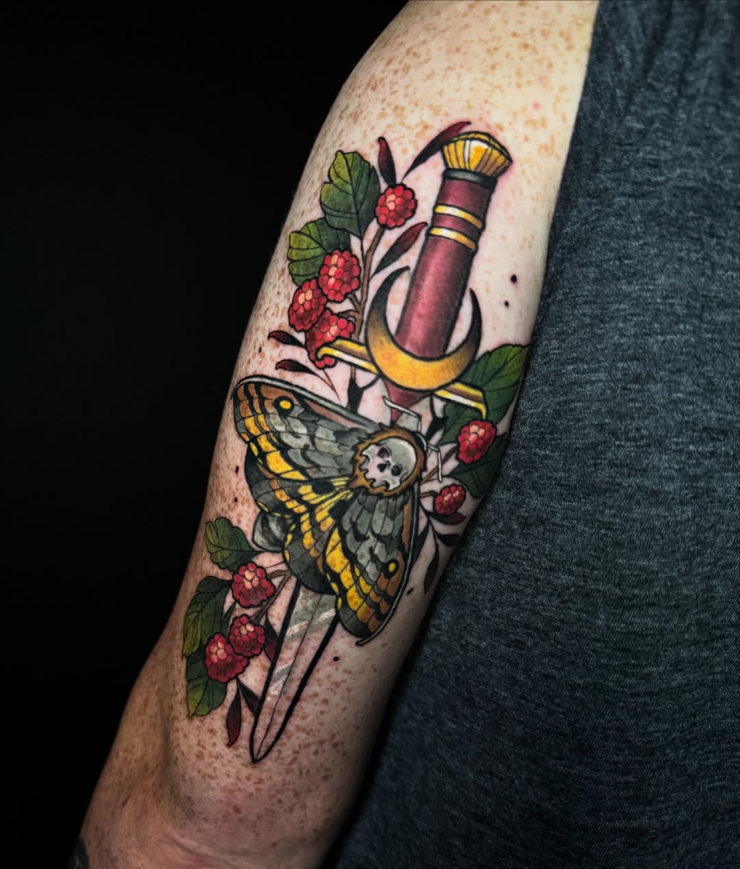 Moth and dagger American traditional tattoo on the forearm by Dee Florian