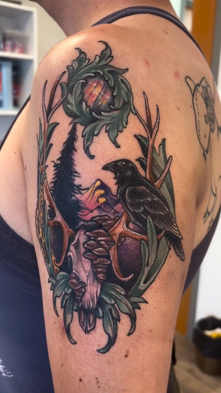 Skull with raven and forest dark art tattoo on the shoulder by Cricket Elijah Cervidae