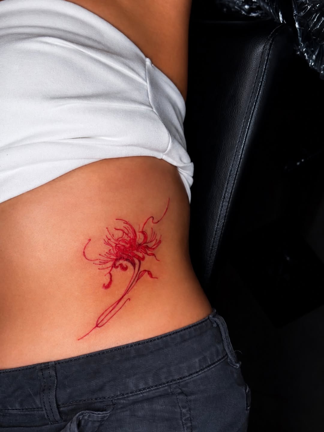 Red spider lily fine line tattoo by Cece, Las Vegas, Nevada