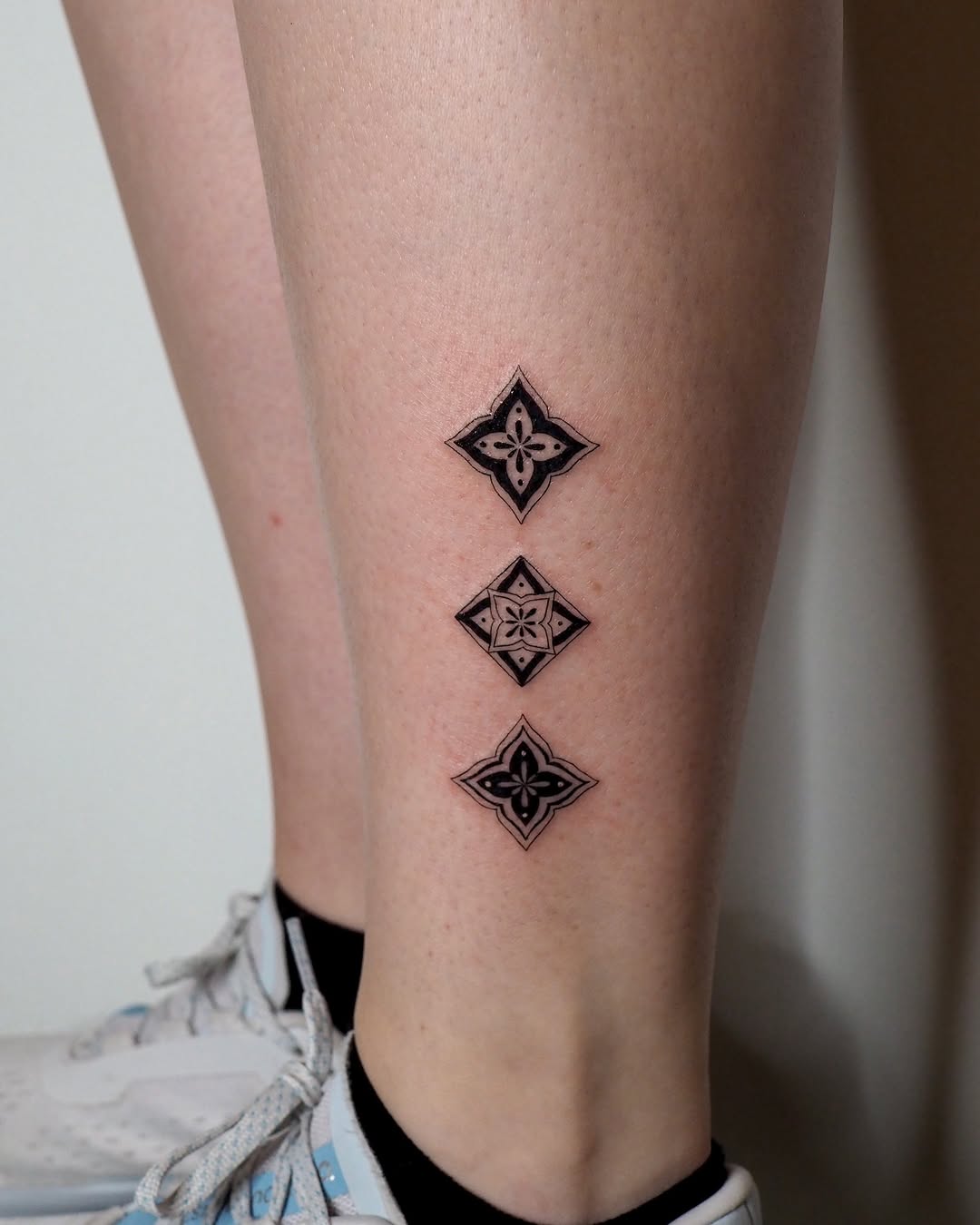 Geometric floral patterns ornamental tattoo on the calf by A. Eye Tat
