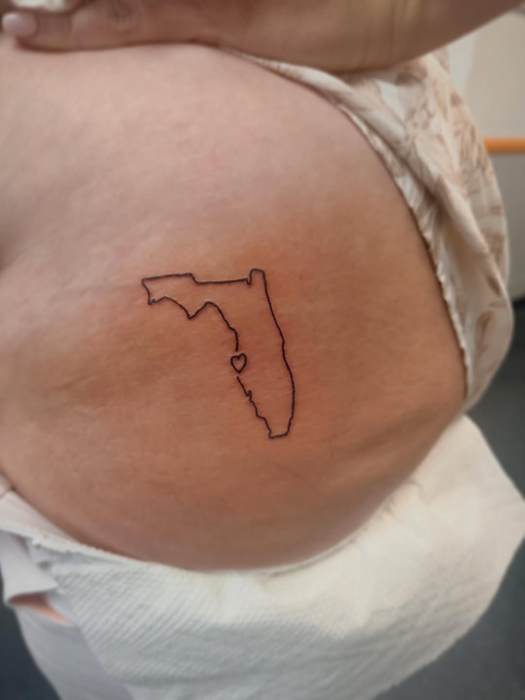 Outline of Florida with a heart fine line tattoo on the torso by Rylan Thorndyke - Tattoo Artist, Las Vegas, Nevada