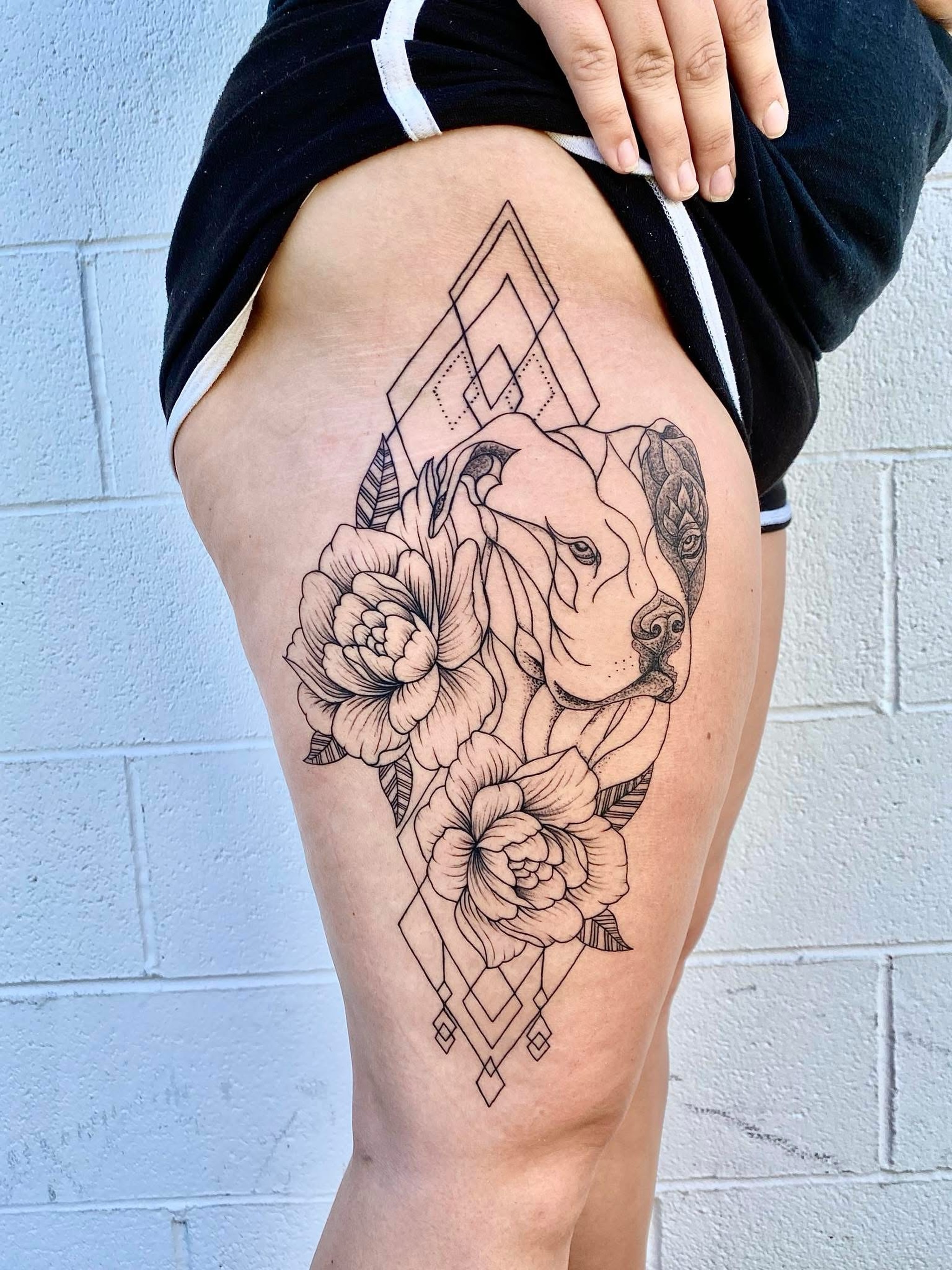 Dog and flowers geometric tattoo on the thigh by Chris Whittaker Tattoo Artist