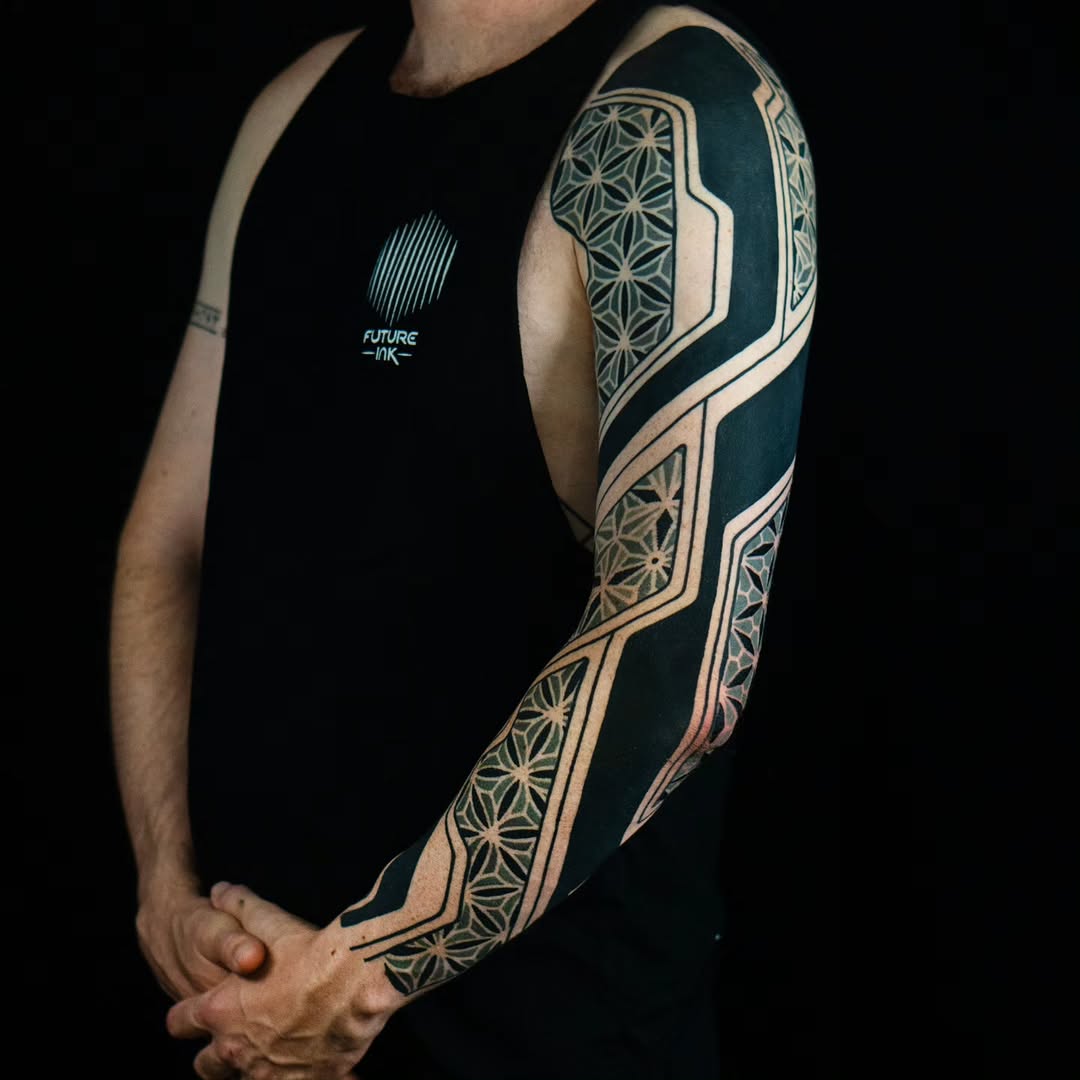 Geometric pattern sleeve geometric tattoo on the upper arm by Kevin Ligabue