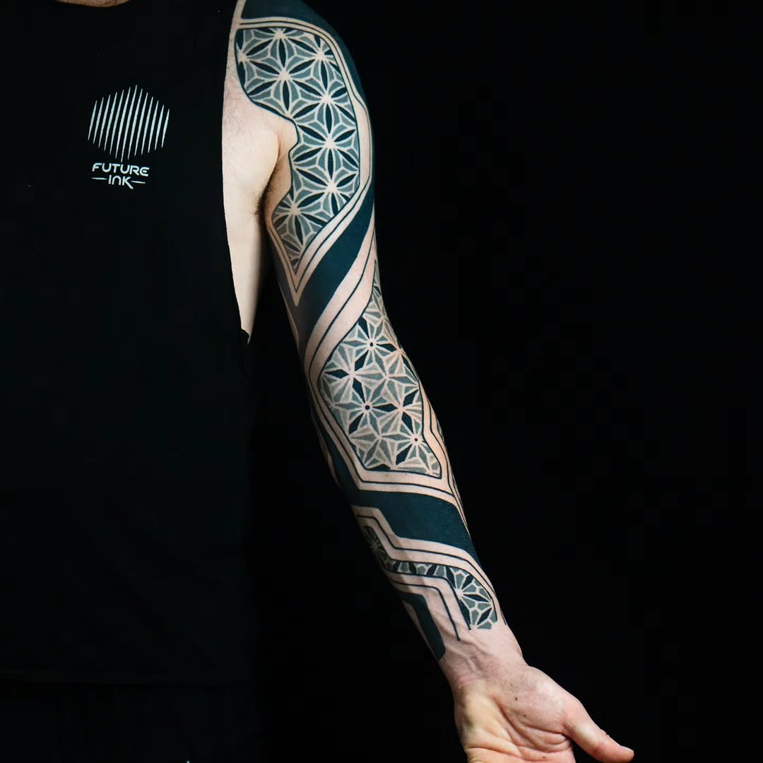 Geometric pattern sleeve geometric tattoo on the upper arm by Kevin Ligabue