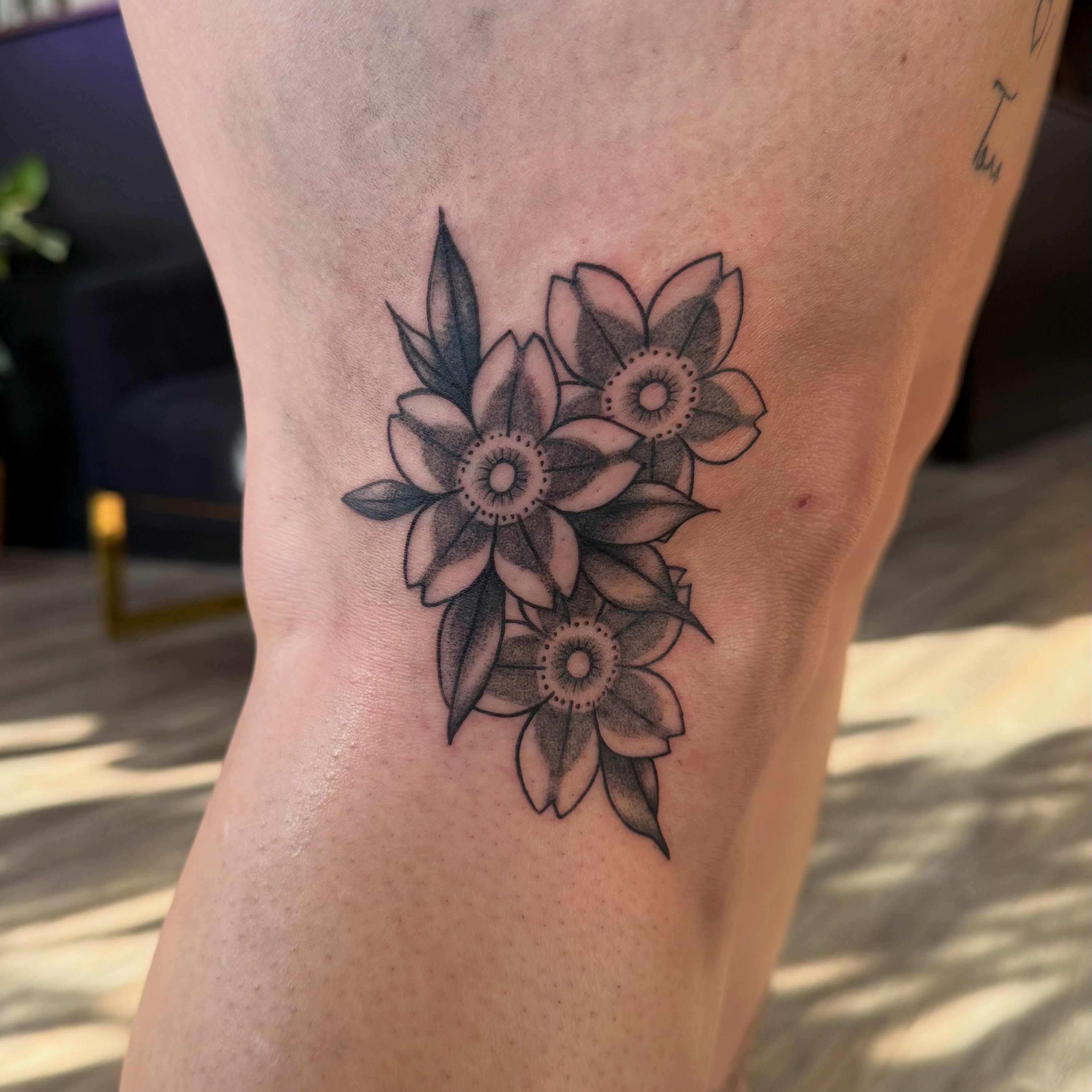 Flowers dotwork tattoo on the thigh by Kate Marie