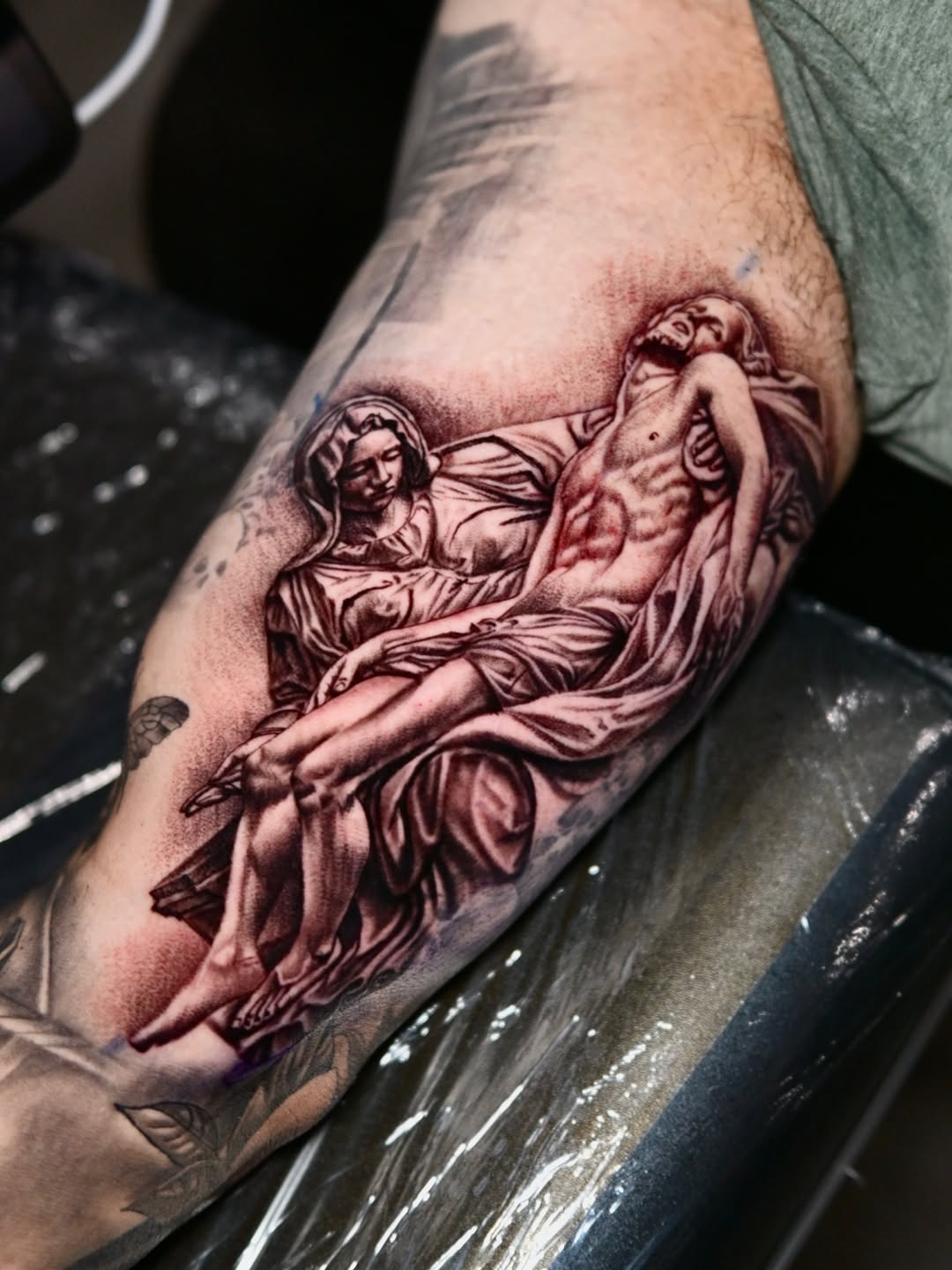 Pieta sculpture Chicano tattoo on the forearm by Dallas tattoo artist