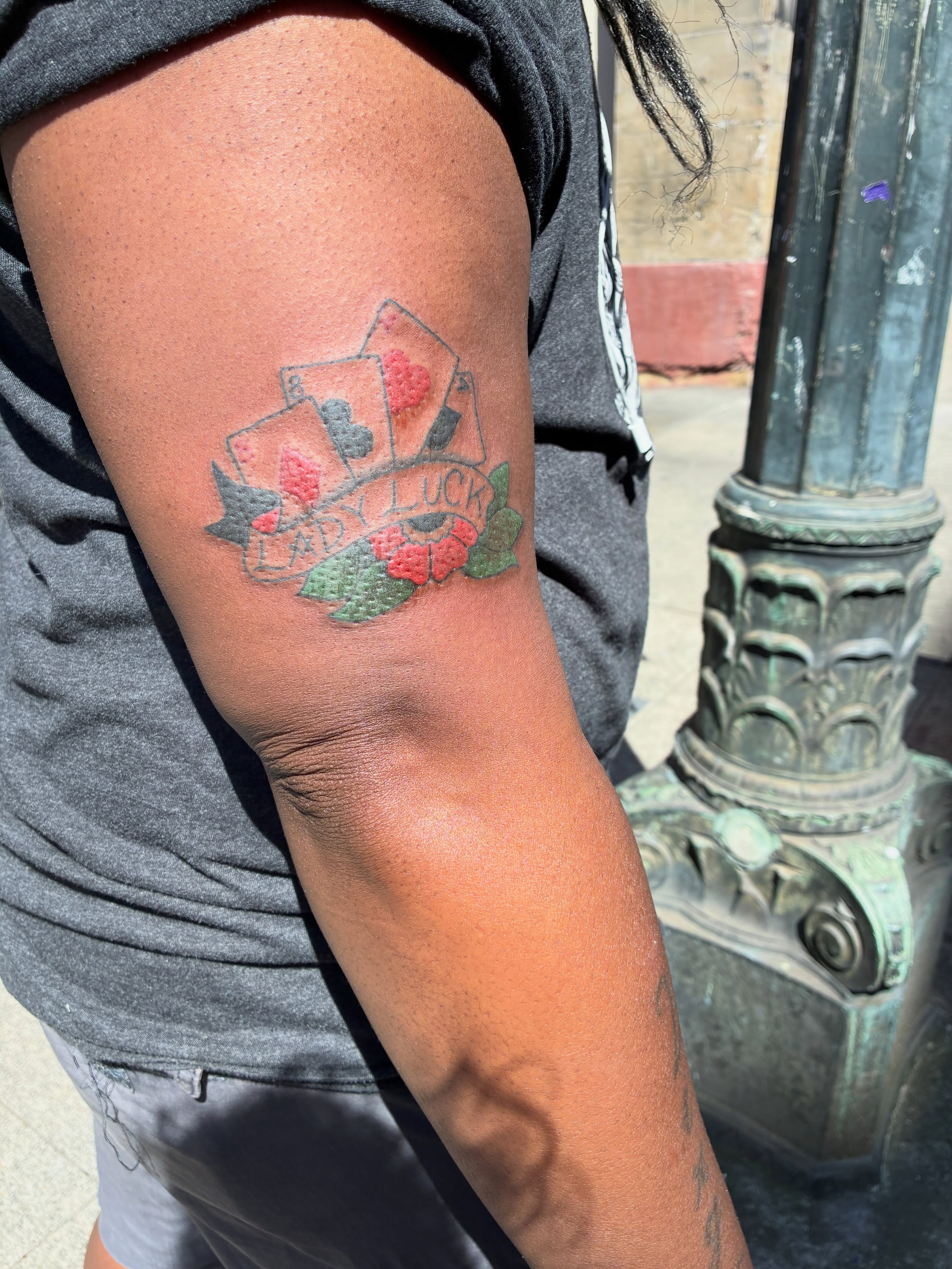 Playing cards and roses American traditional tattoo on the forearm by Seattle Tattoo Artist