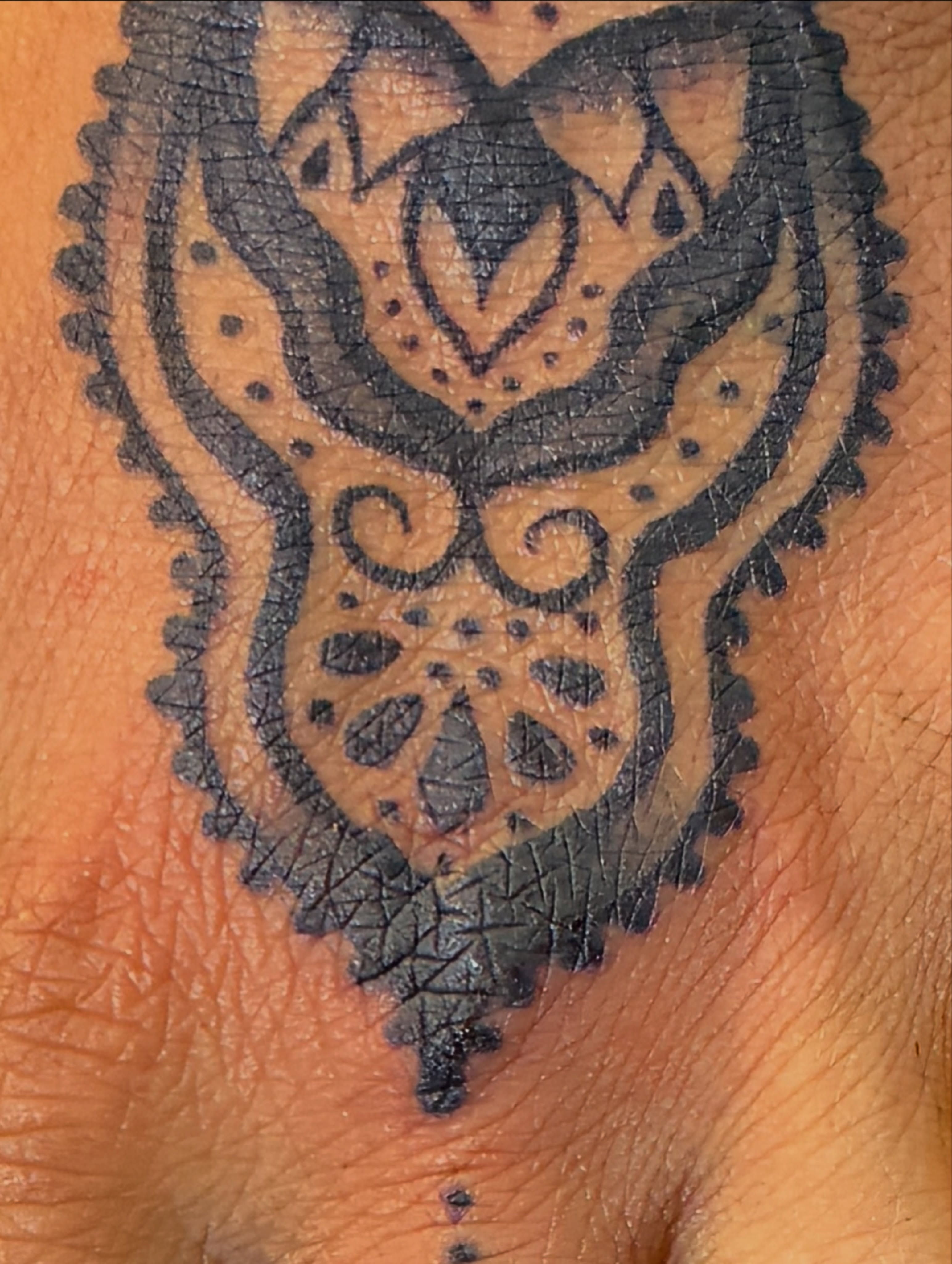 Tribal mask tribal tattoo on the forearm by Seattle Tattoo Artist