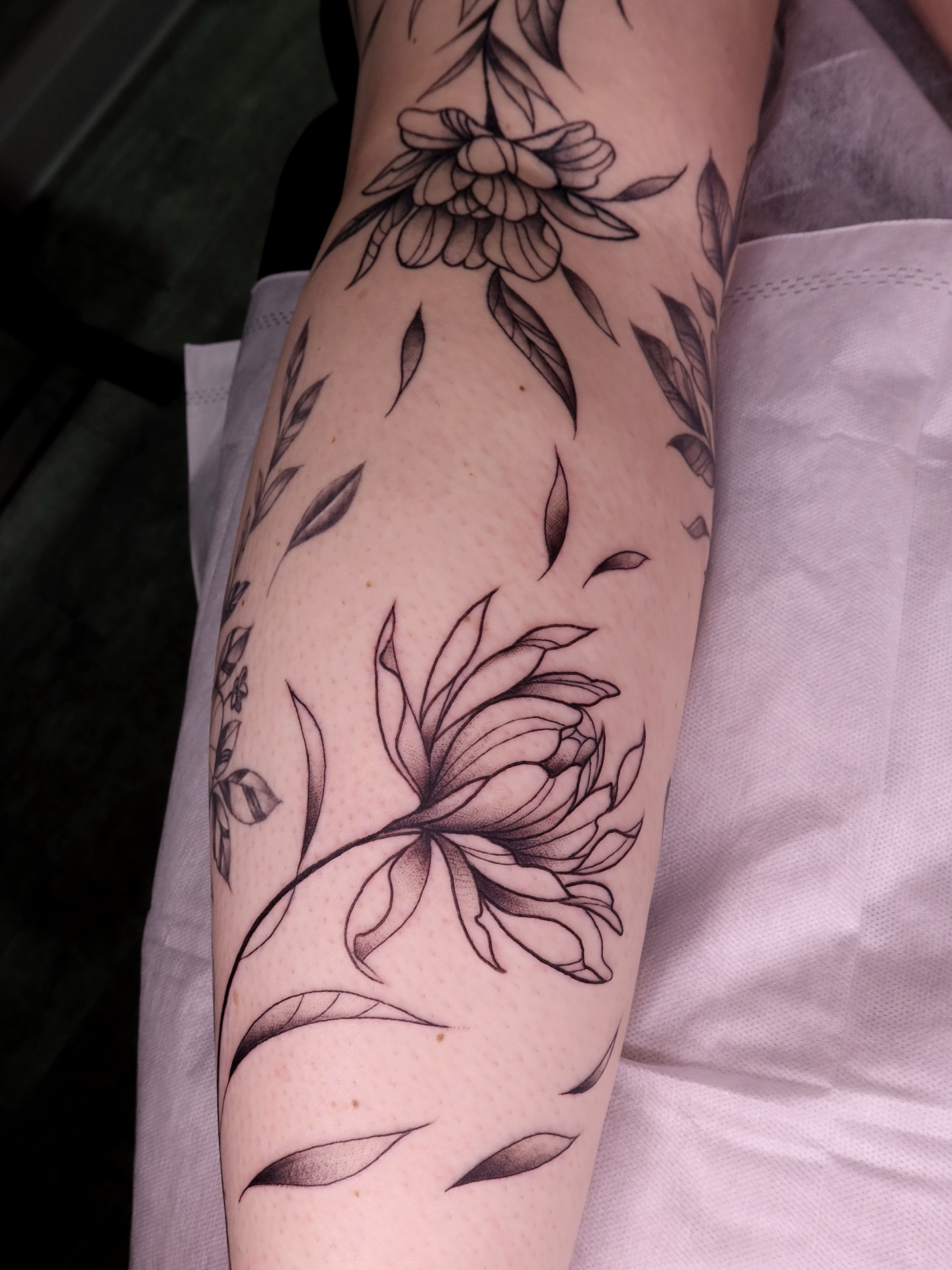 Floral arrangement black and grey tattoo on the forearm by Lexgetink