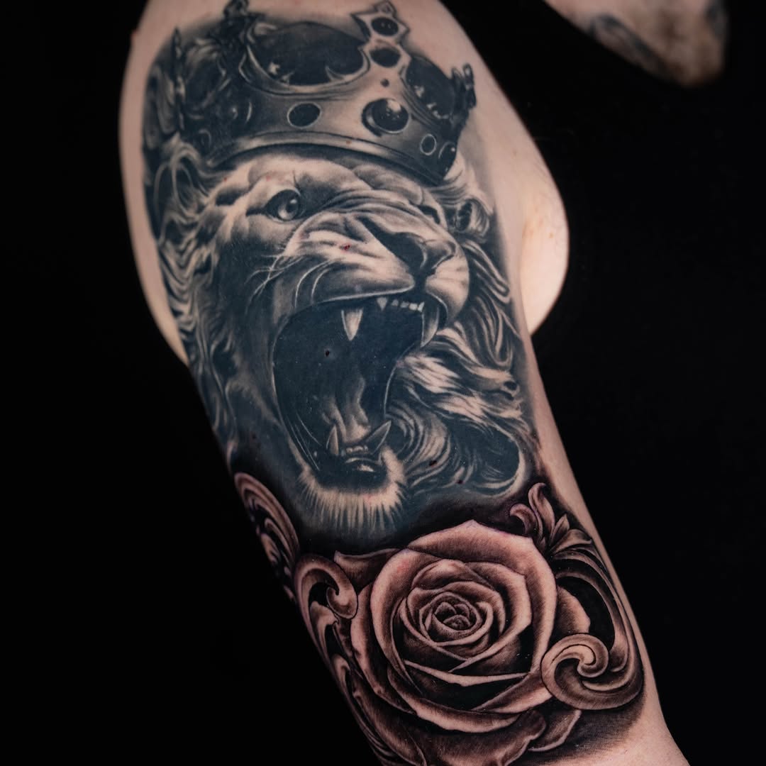 Lion with crown and rose realism tattoo on the forearm by Keebs