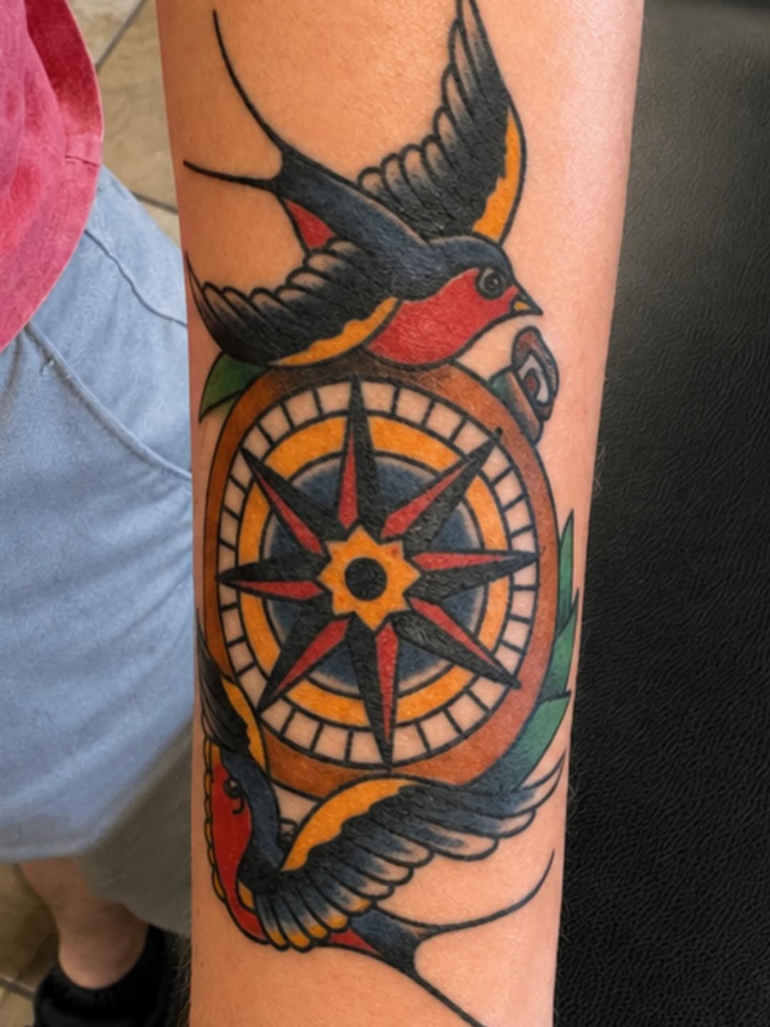 Compass and swallows American traditional tattoo on the forearm by Stoney