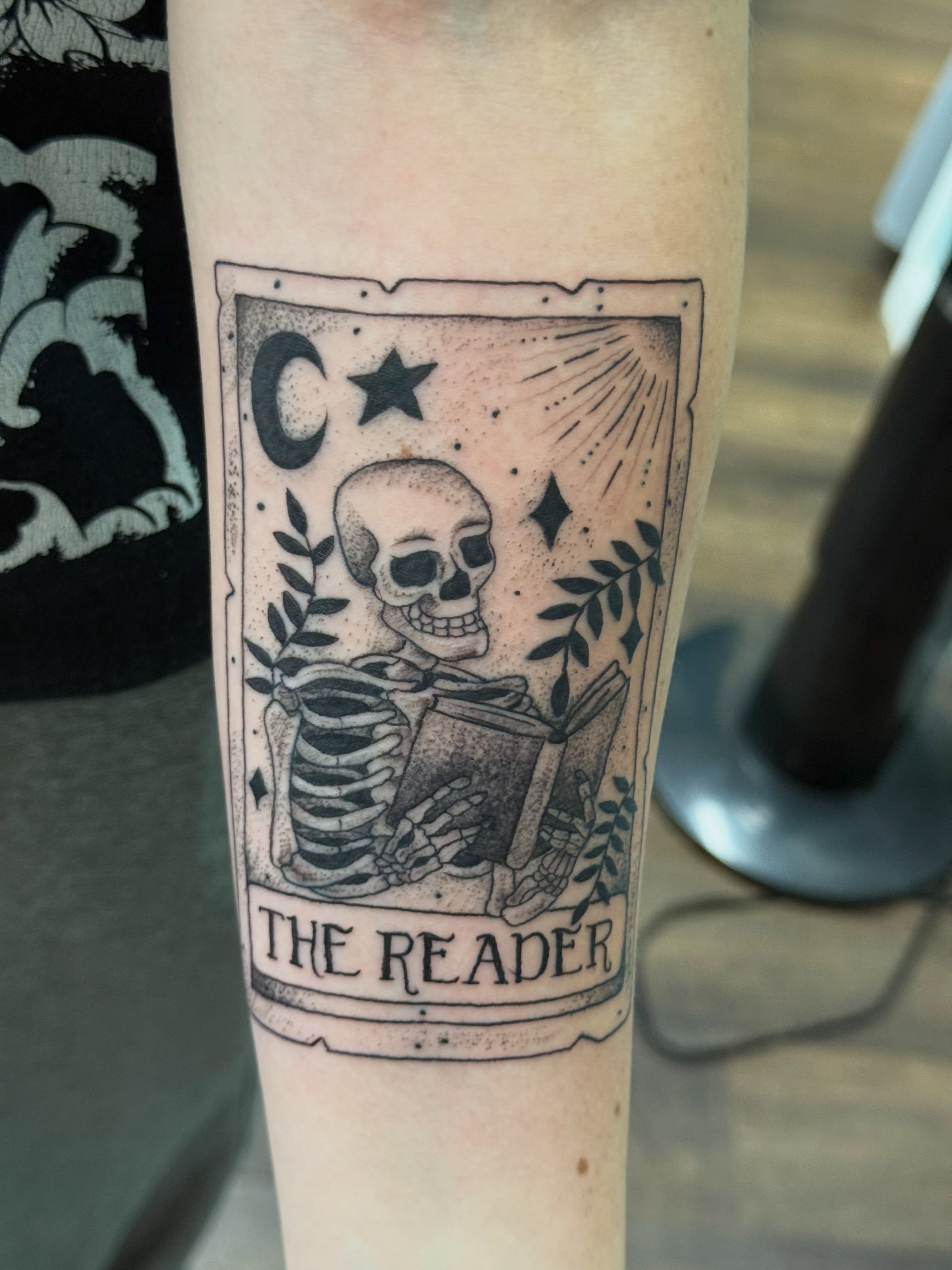 The reader tarot card black and grey tattoo on the forearm by Michelle Balhan