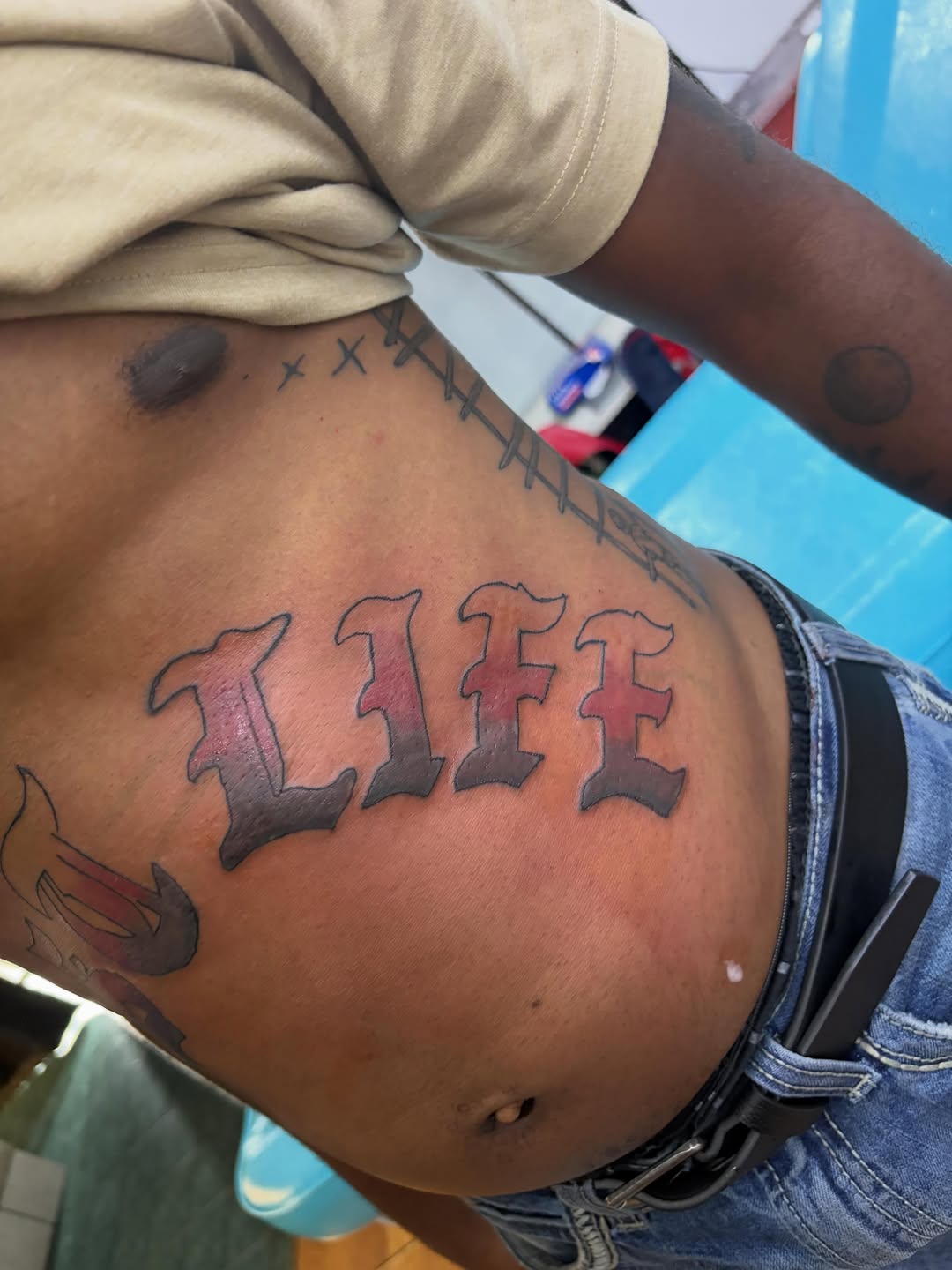 LIFE text tattoo on the ribs by Jae the artist🫡