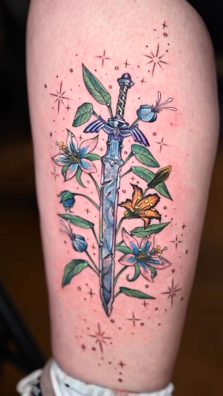Master Sword with flowers and butterflies illustrative tattoo by Ori Merchan Tattoo, Kansas City, Missouri