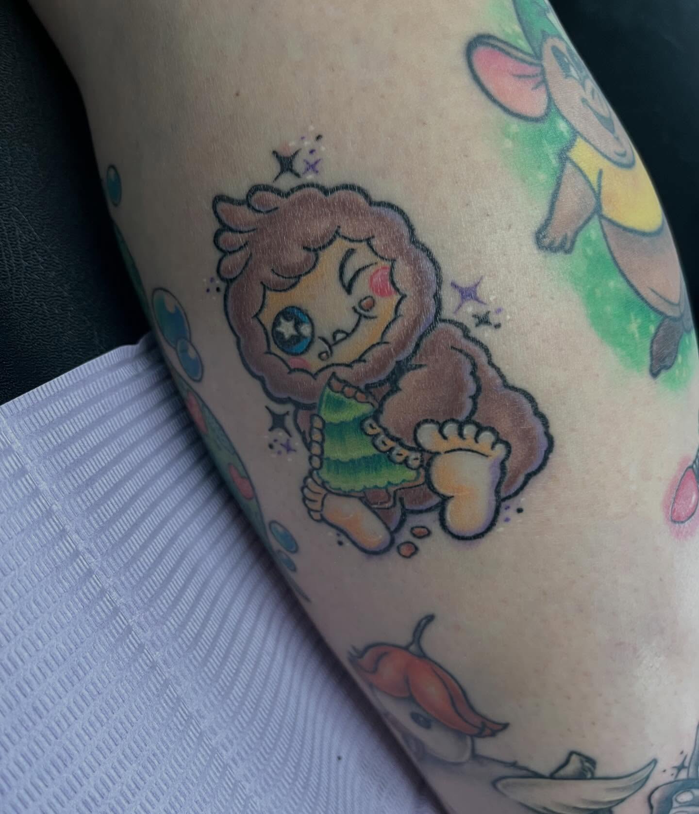Chibi character dotwork tattoo on the forearm by Ash Wheeler