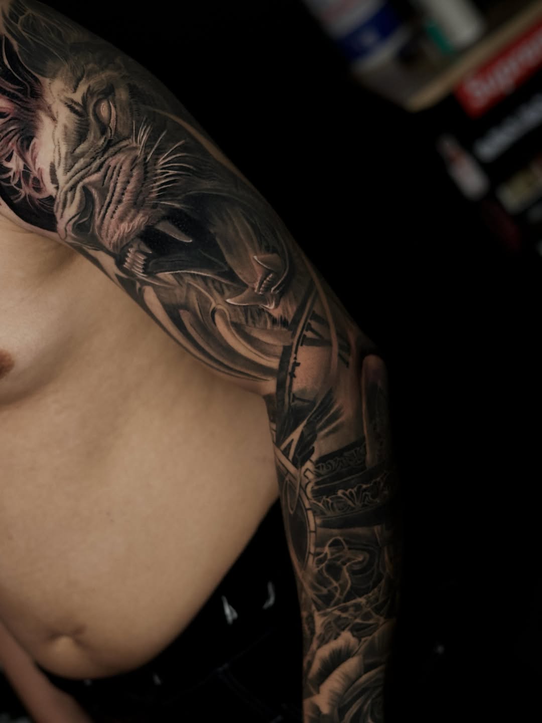 Lion head and clockwork Japanese tattoo on the upper arm by Bapone