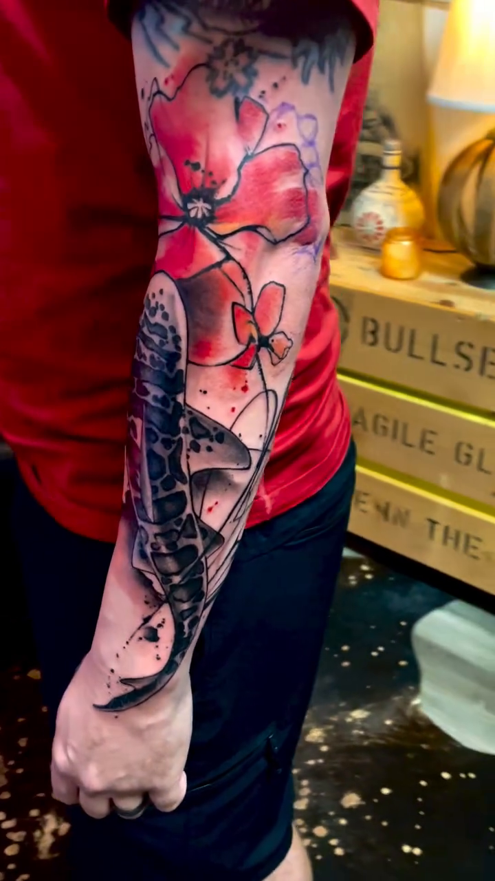 Koi fish with poppies watercolor tattoo on the forearm by David Garner, Los Angeles, California