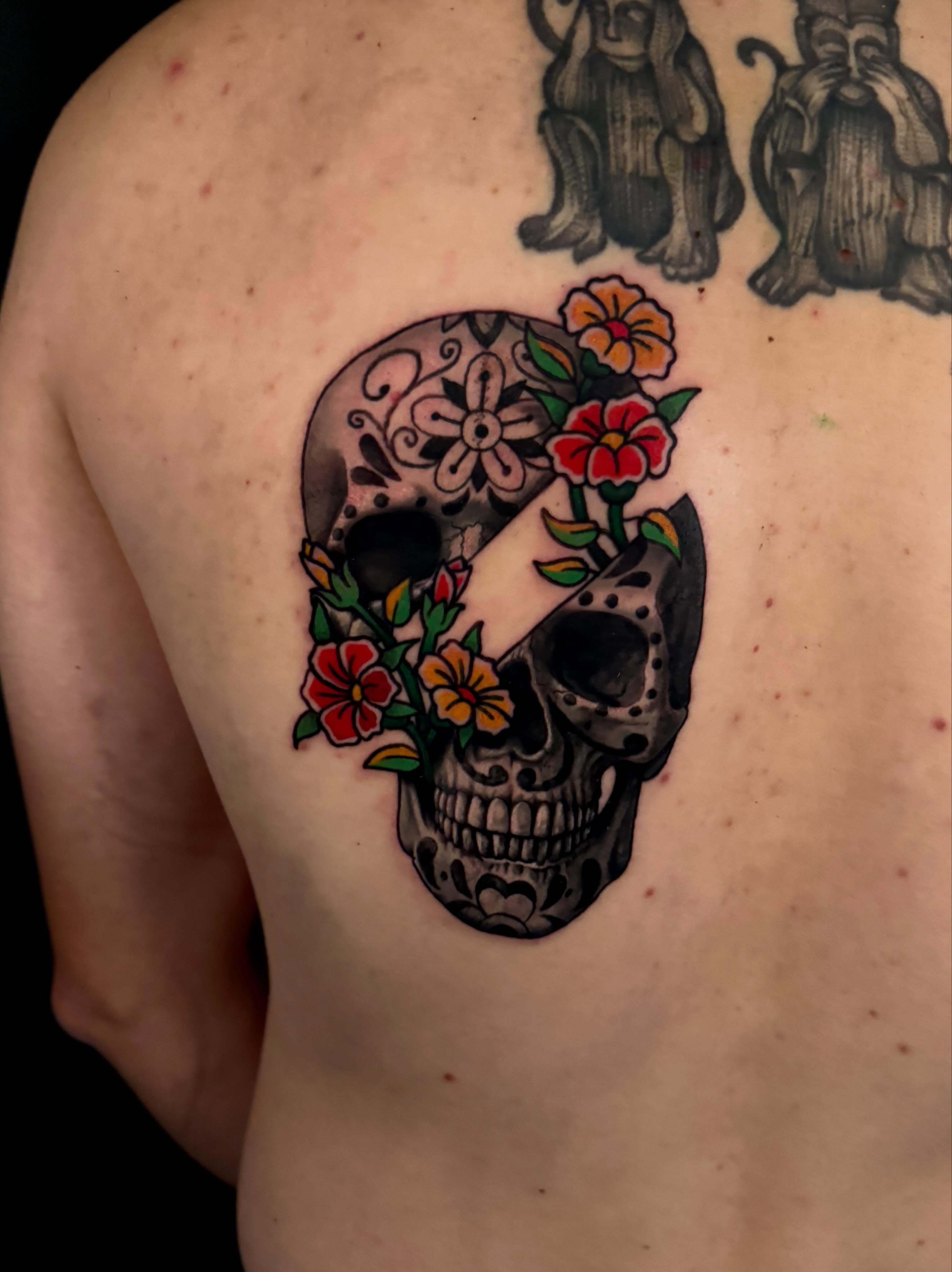 Sugar skull with flowers American traditional tattoo on the shoulder by Dallas Tattoo Artist