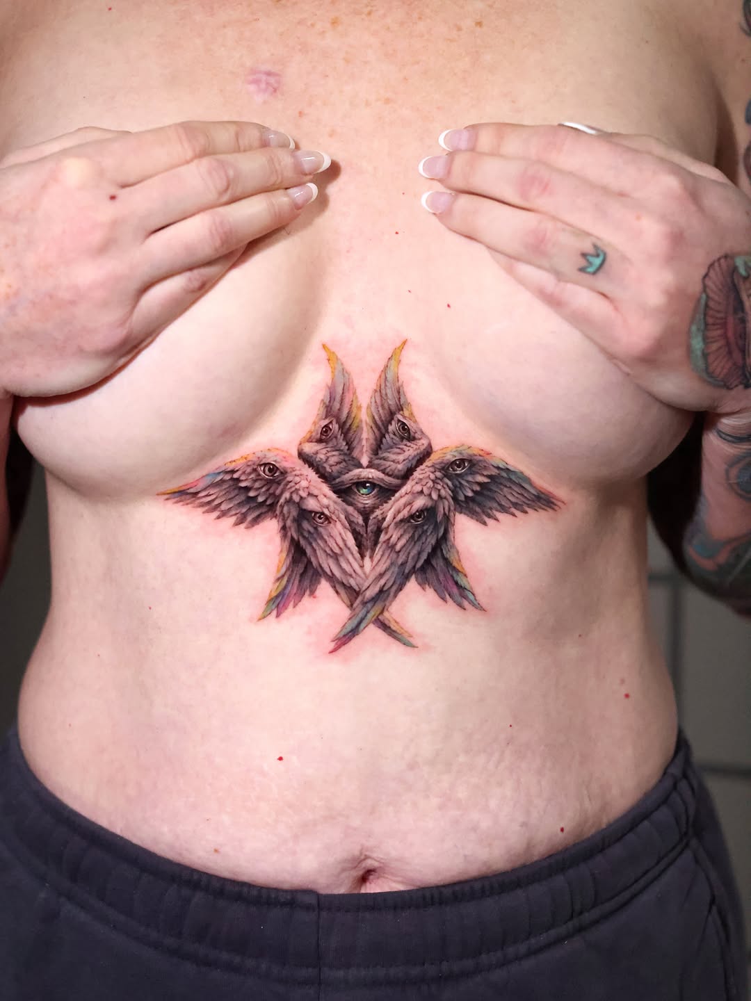 Angelic eyes and wings neo-traditional tattoo on the torso by Eun, Toronto, Ontario