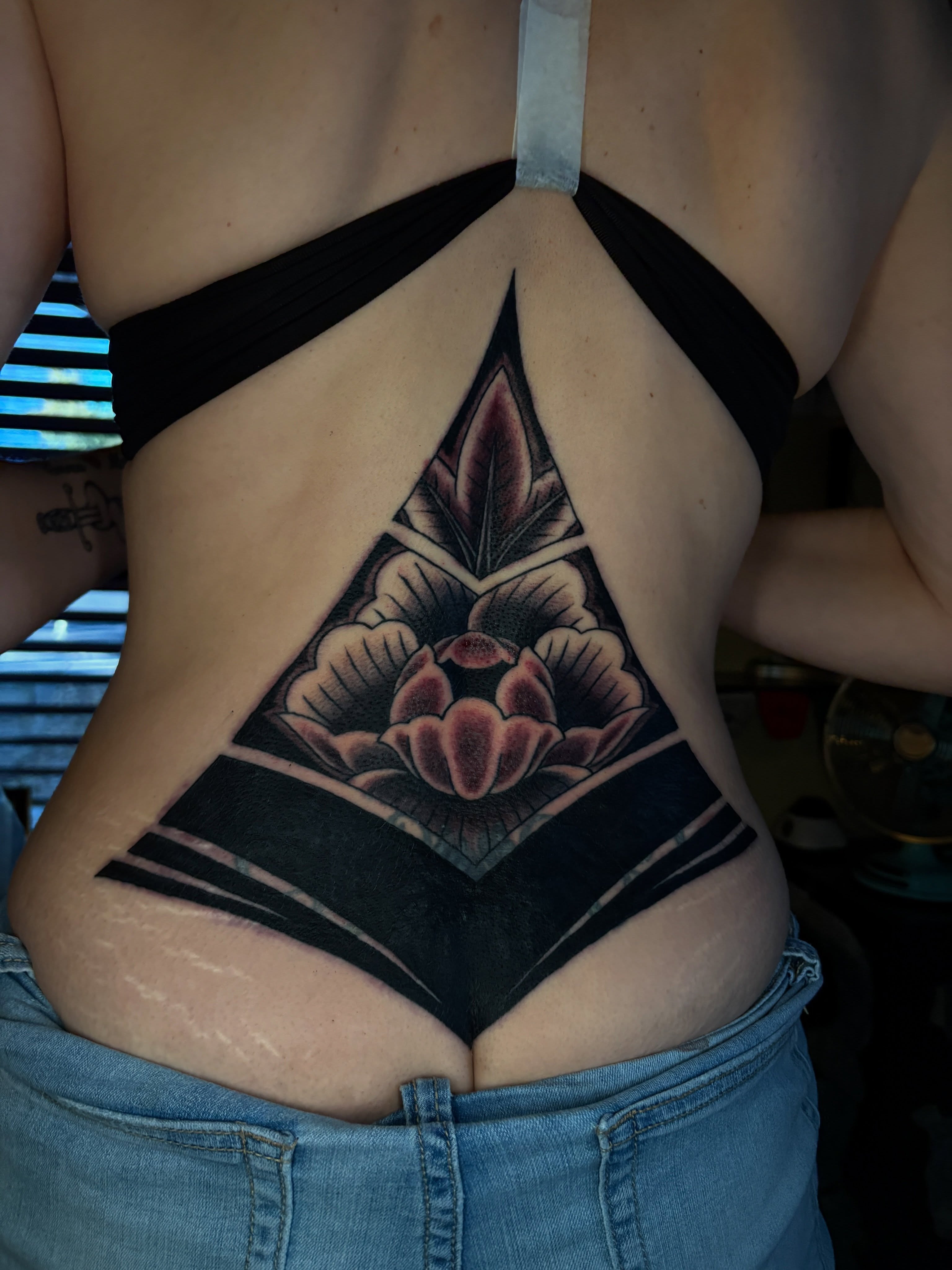 Lotus flower geometric tattoo on the torso by Max Klapp, Austin, Texas