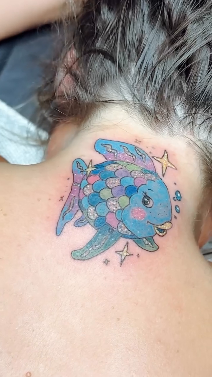 Cartoonish fish and a lighter new school tattoo on the thigh by Felicia Lee, Des Moines, Iowa