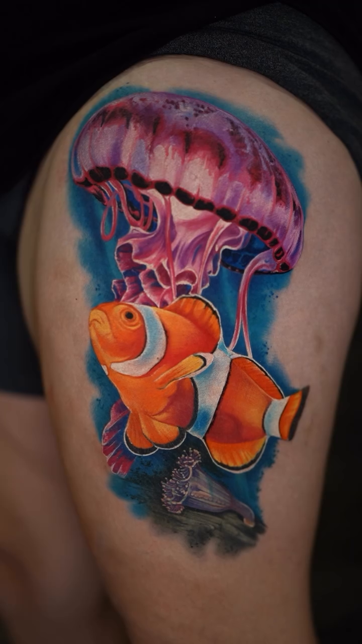 Clownfish and jellyfish realism tattoo by Ink Warden  Tattoo