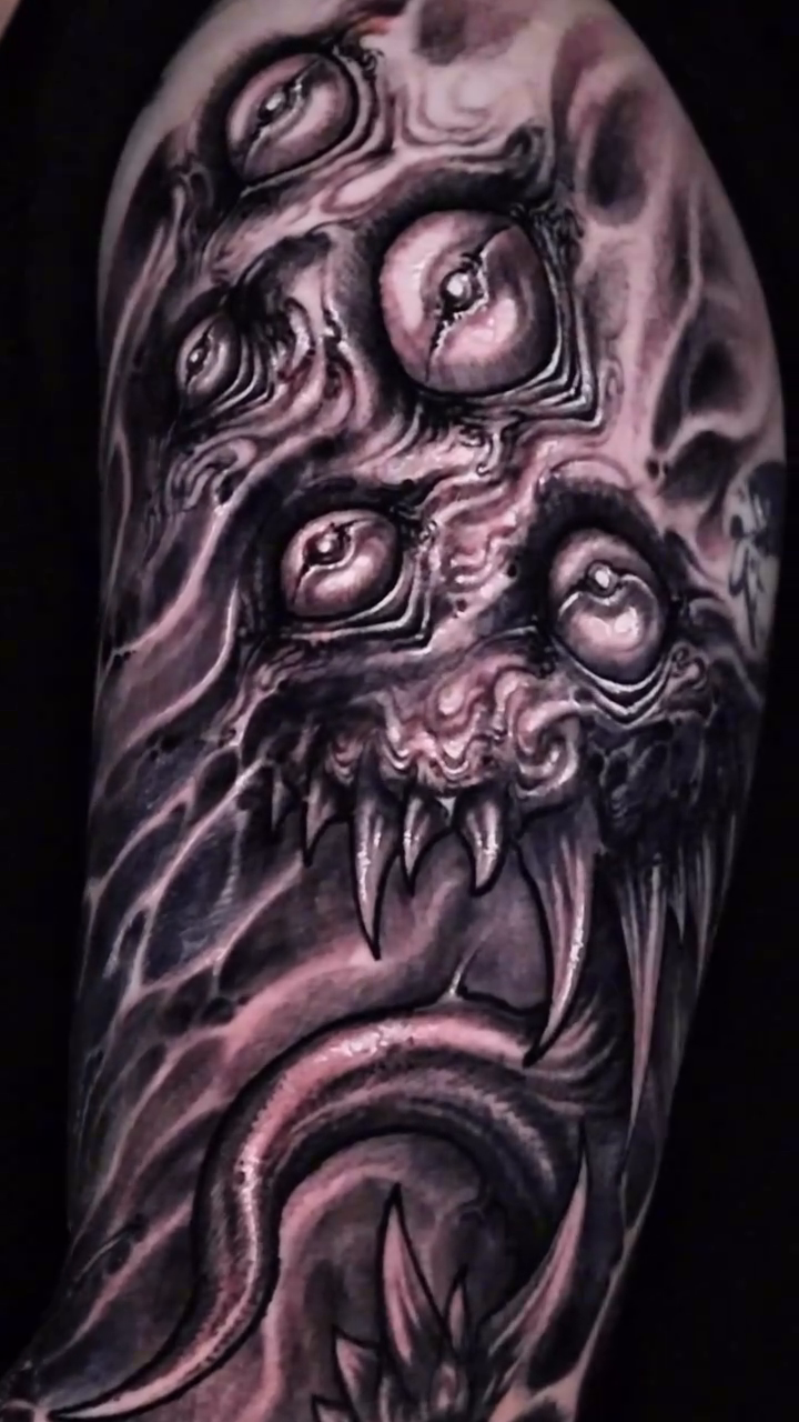 Multi-eyed demonic creature dark art tattoo on the forearm by Dark tattoo
