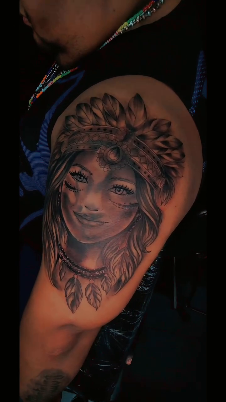 Woman with headdress realism tattoo on the upper arm by Kai_Tattoo