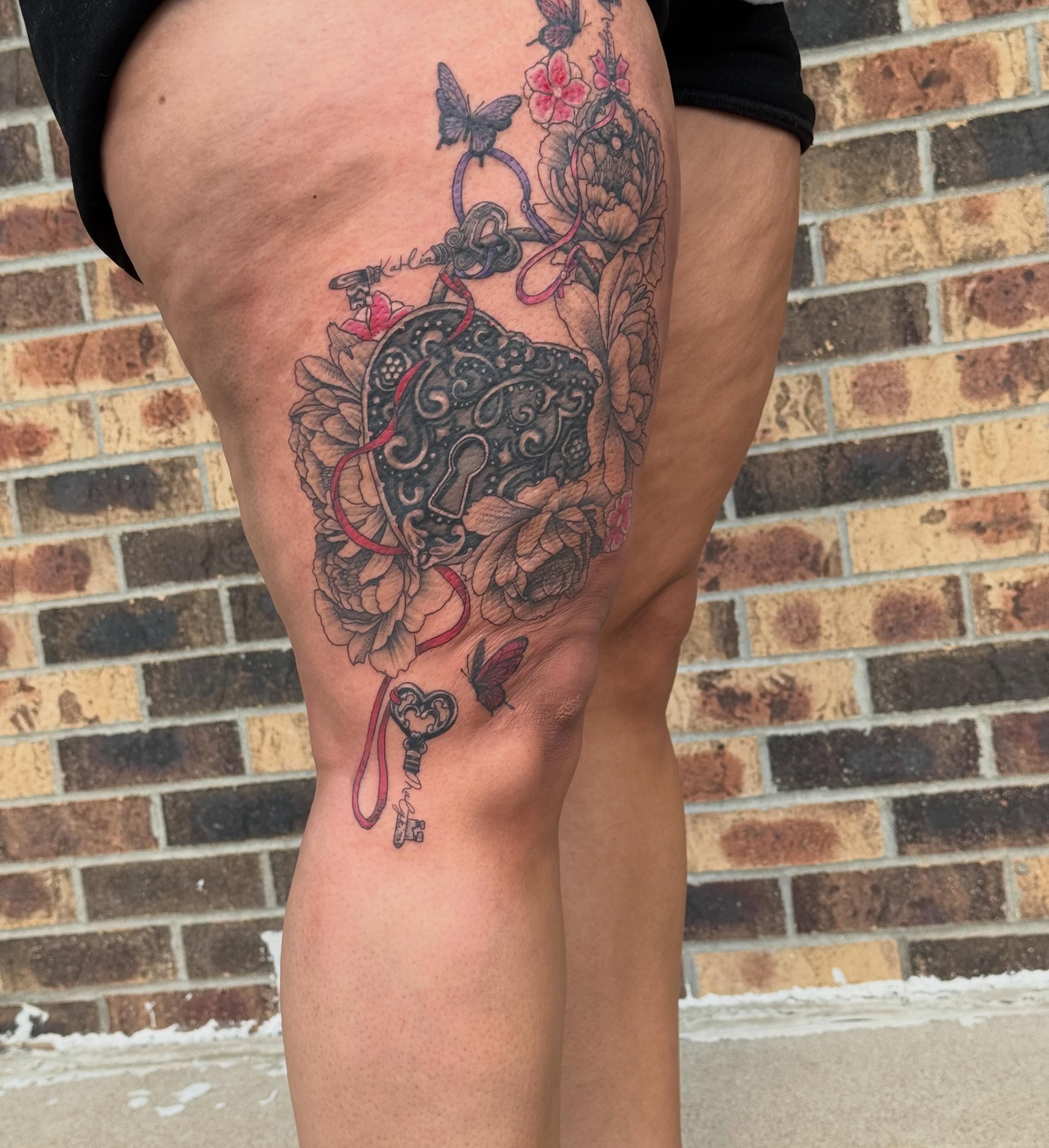 Key and floral arrangement ornamental tattoo on the thigh by Lauren Horness