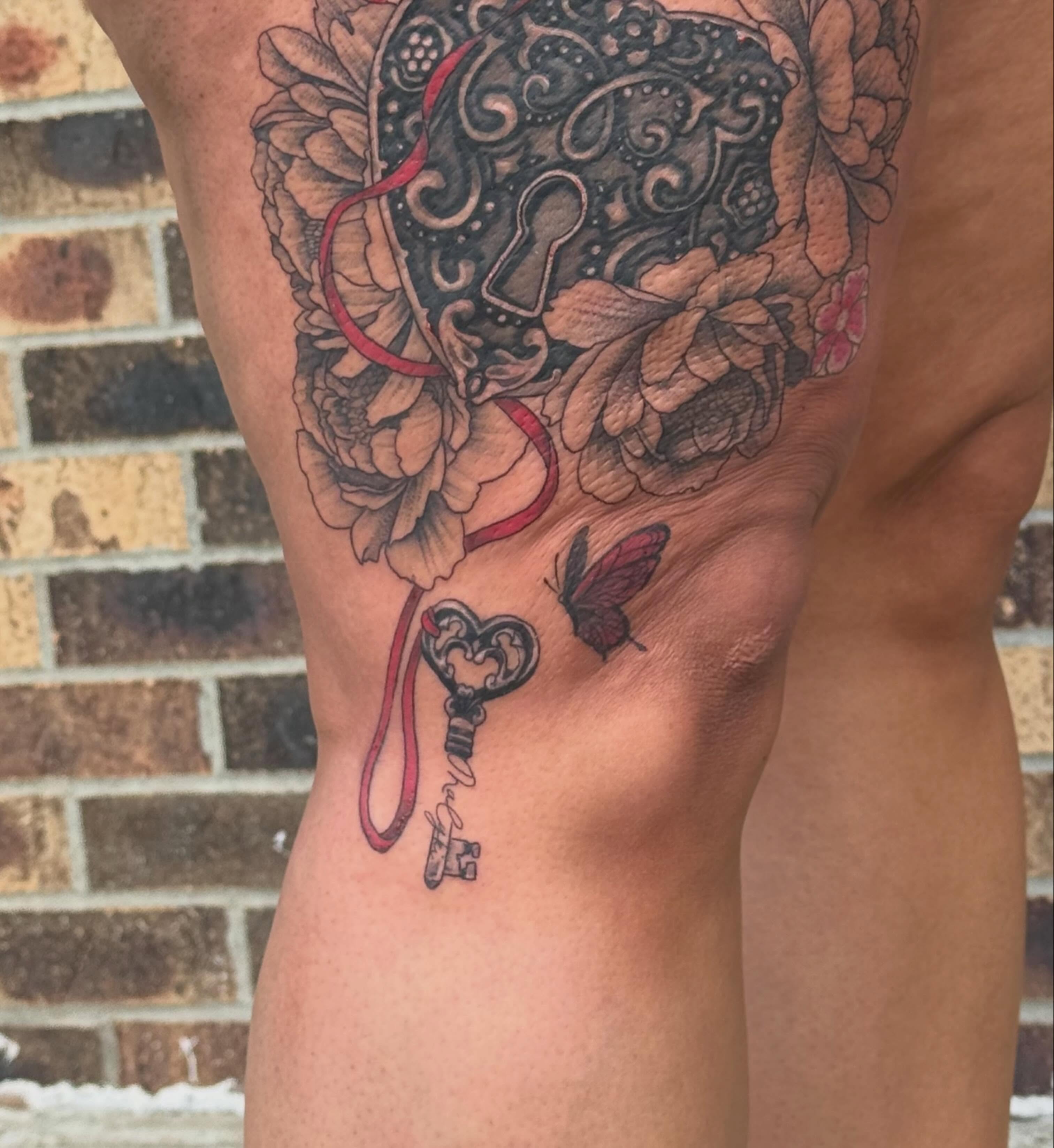 Keyhole and floral ornamental tattoo on the thigh by Lauren Horness