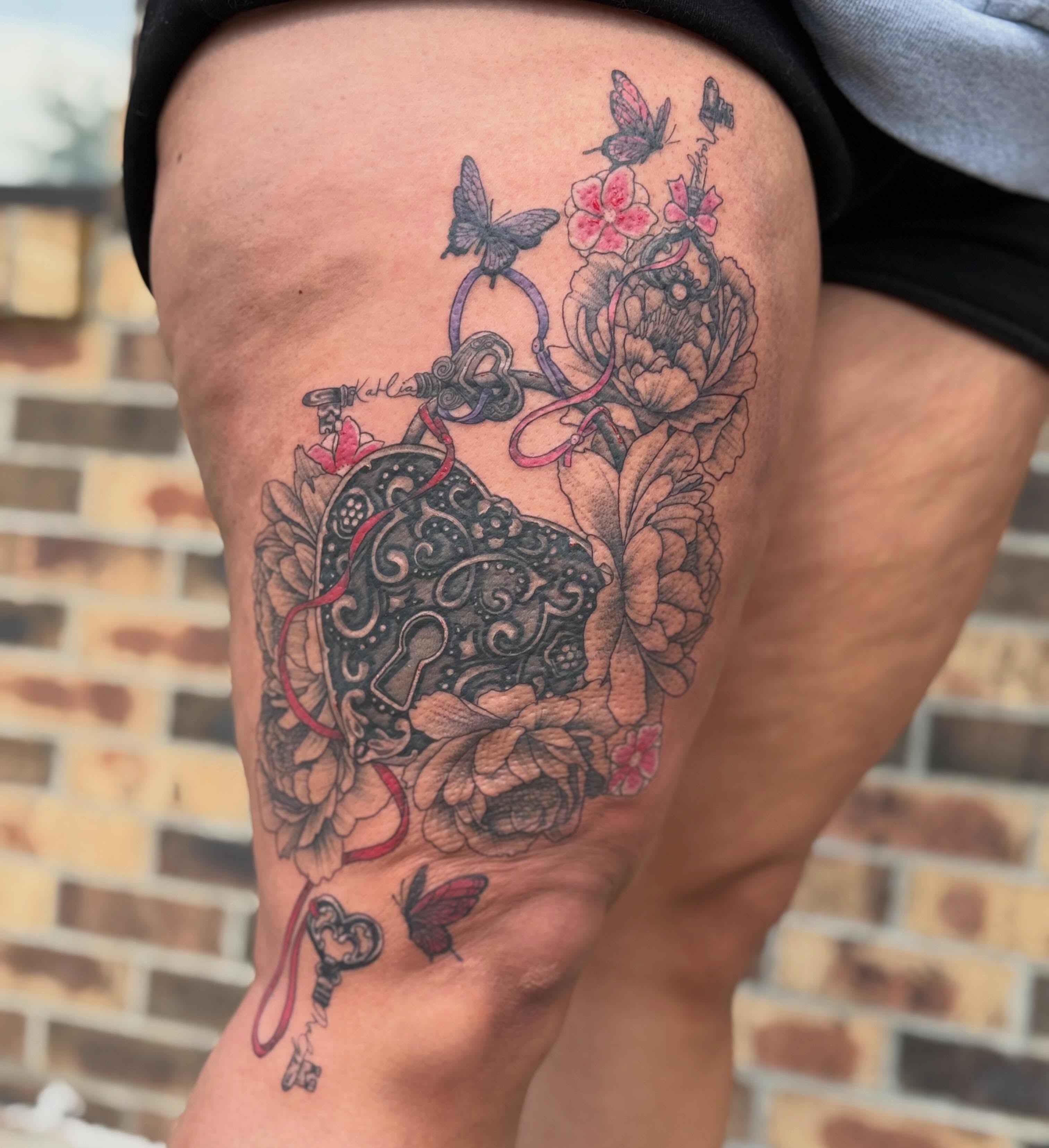 Lock and key with floral elements ornamental tattoo on the thigh by Lauren Horness