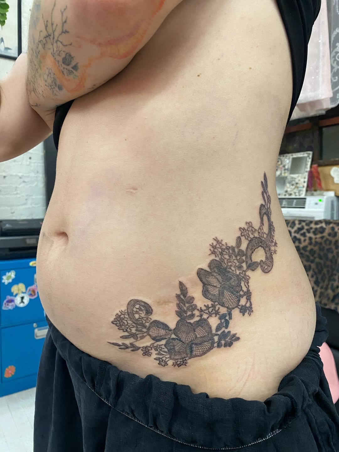 Lace and floral pattern dotwork tattoo on the torso by °₊⊹ delia ✩ jane ೃ࿔*