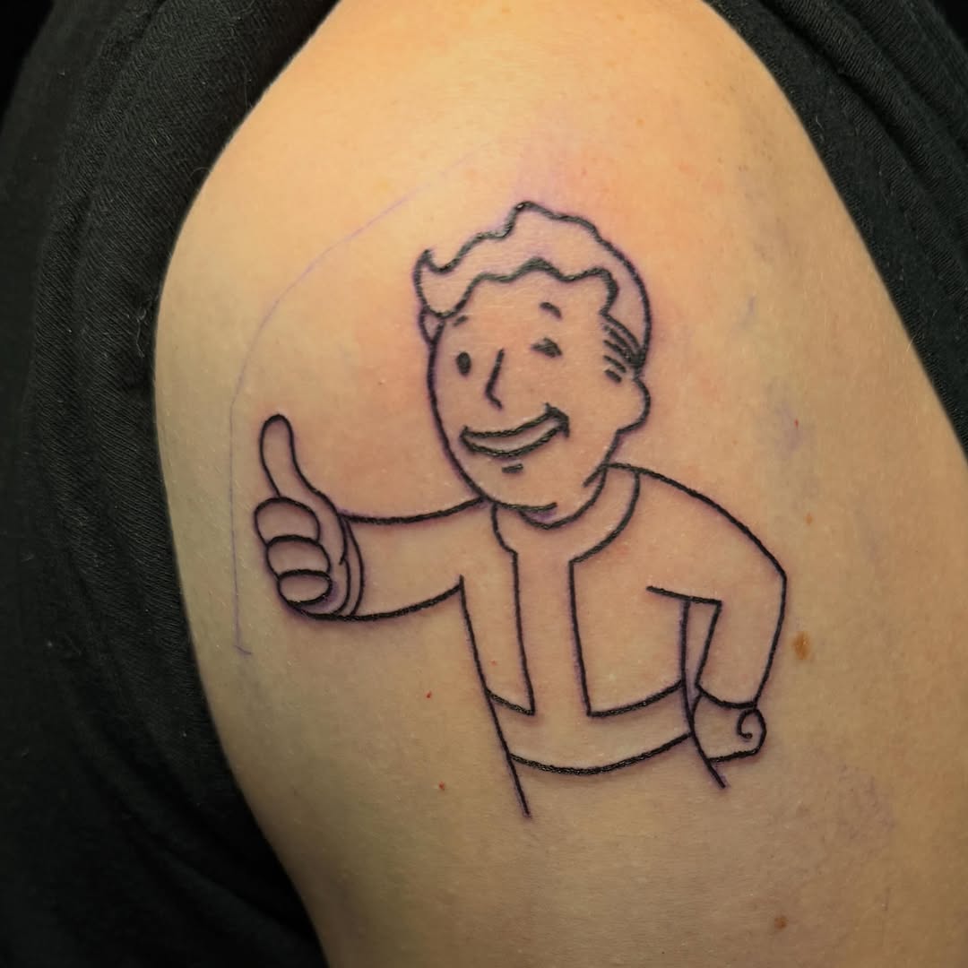Vault Boy giving thumbs up new school tattoo on the shoulder by Scout Meyer