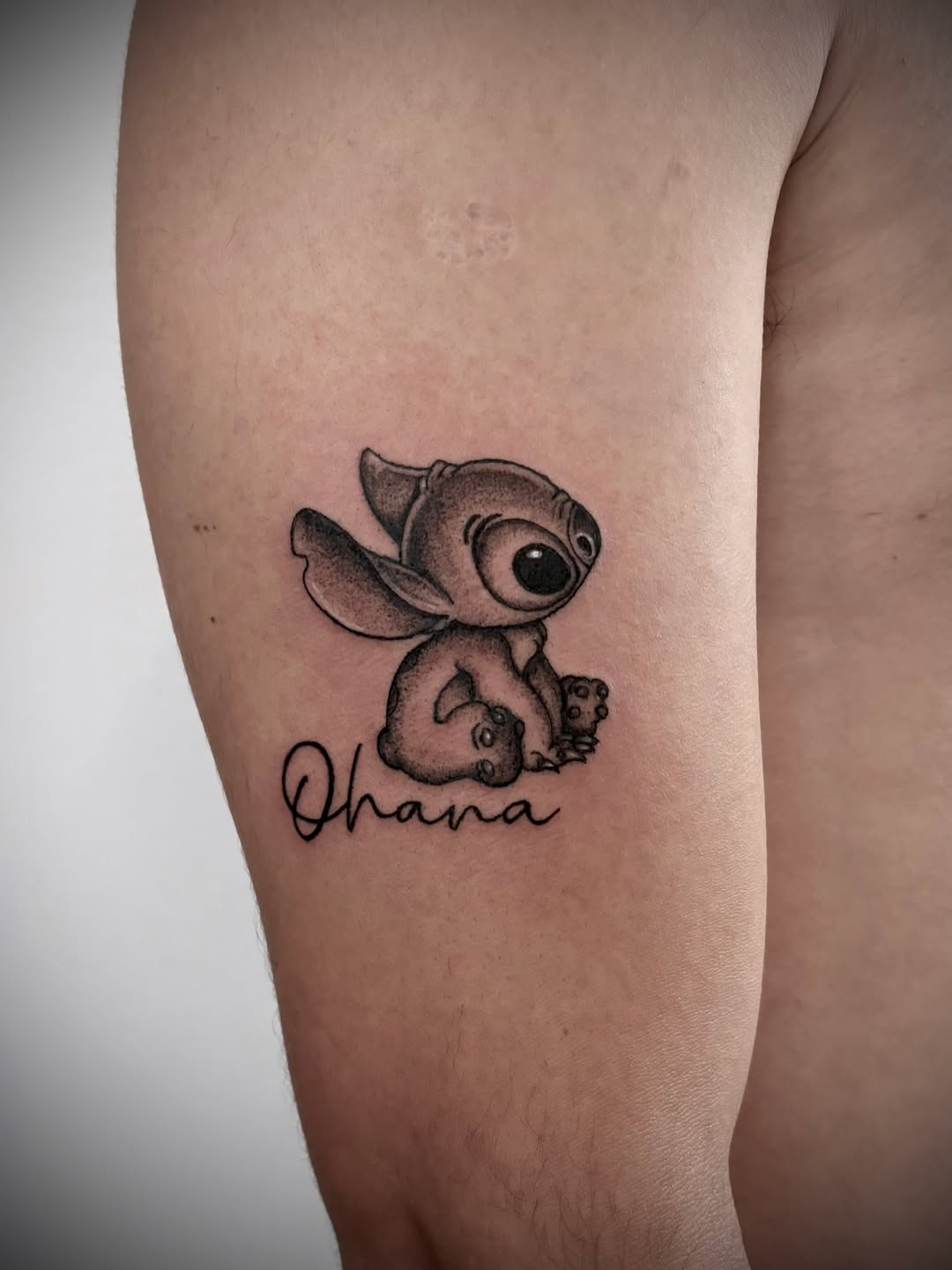 Stitch with 'Ohana' text new school tattoo on the forearm by Deborah