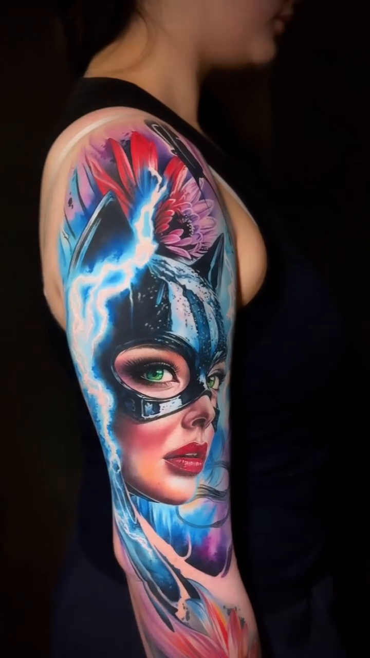Surrealism tattoo on the upper arm by Tony Ink