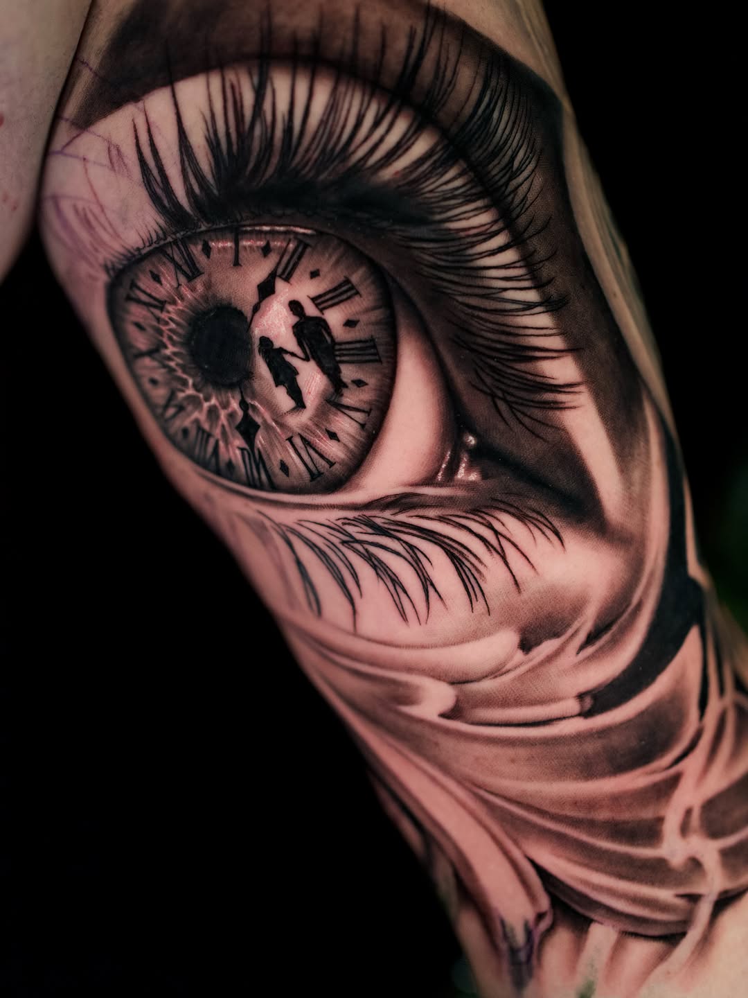 Eye with clock and figures surrealism tattoo on the forearm by April Lynn