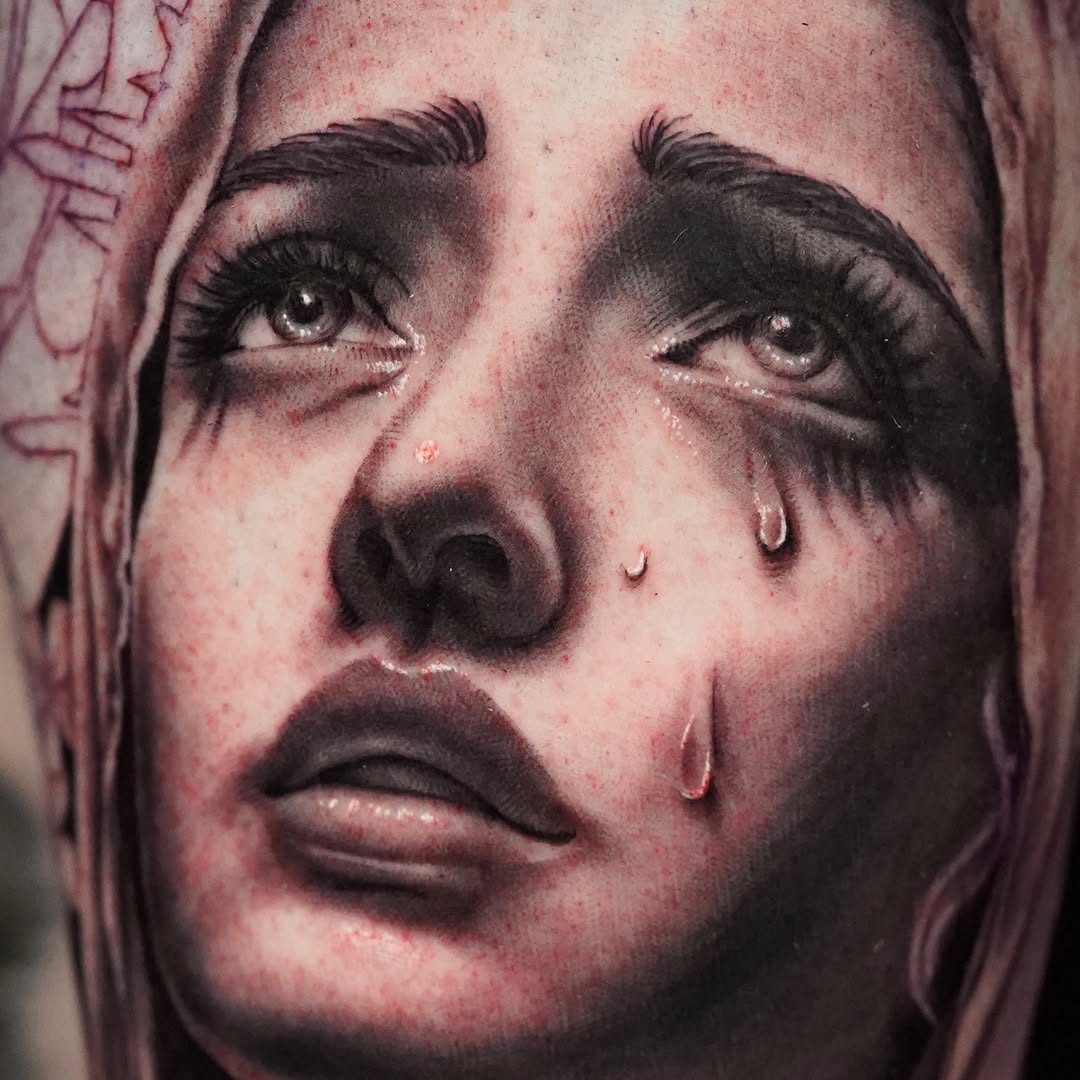 Crying woman's face realism tattoo on the forearm by April Lynn