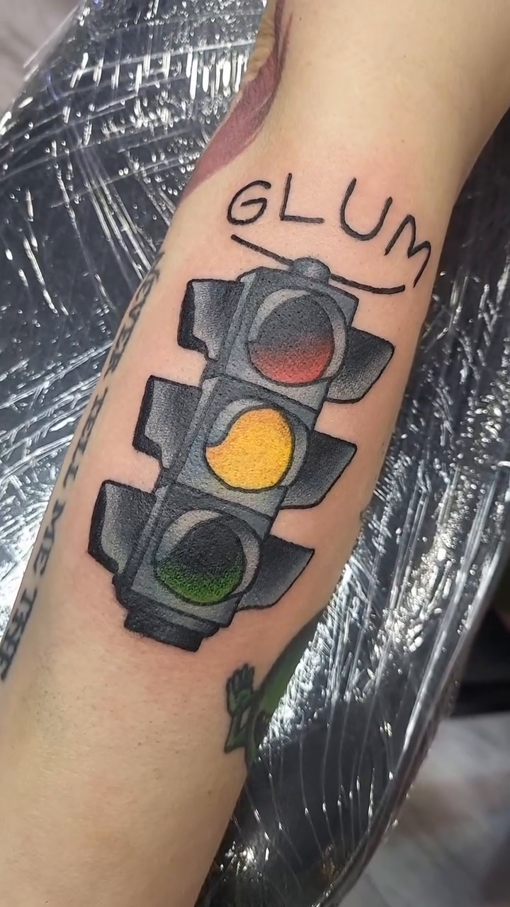 Traffic light tattoo on the forearm by Sloan Smith