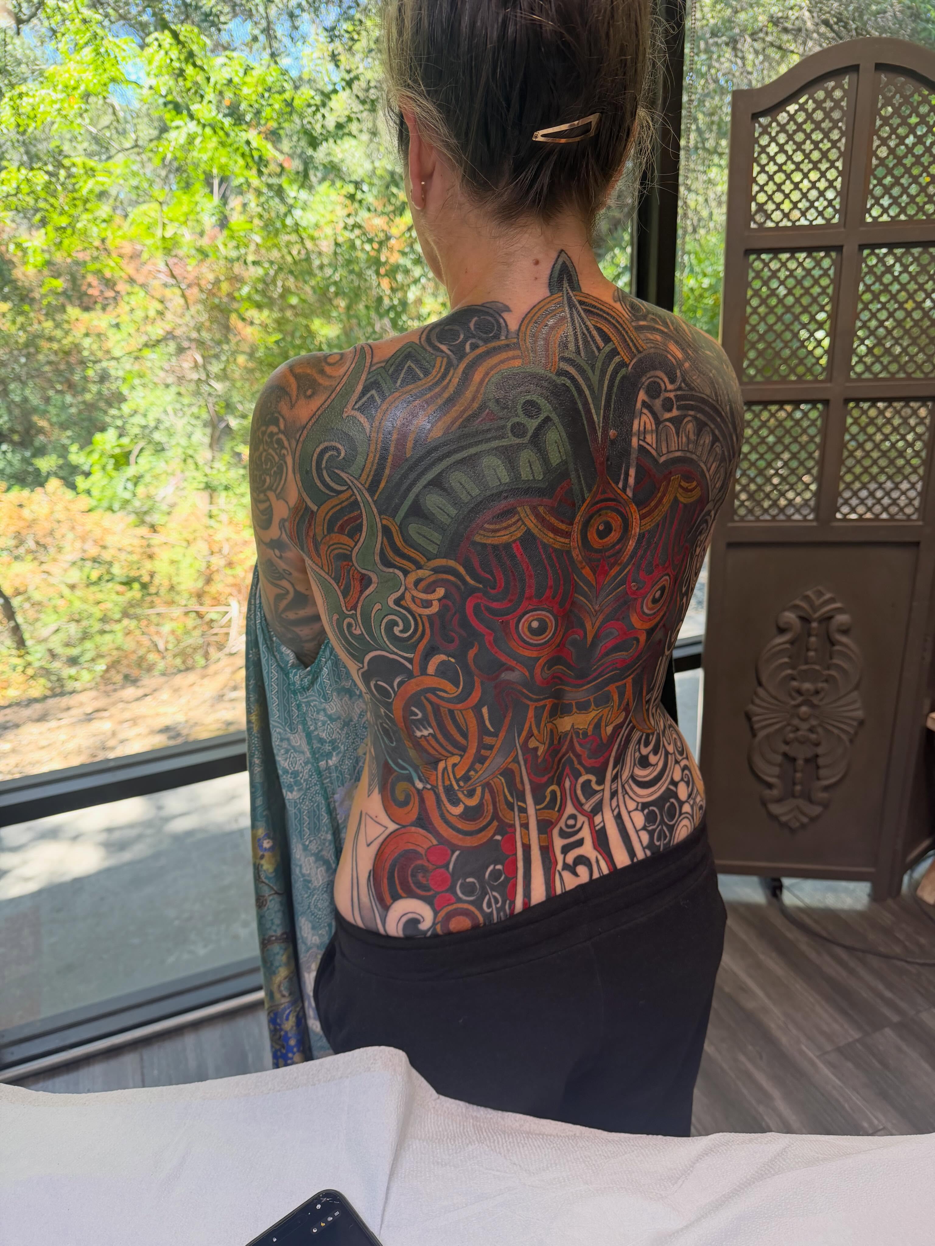 Abstract design geometric tattoo on the back by <