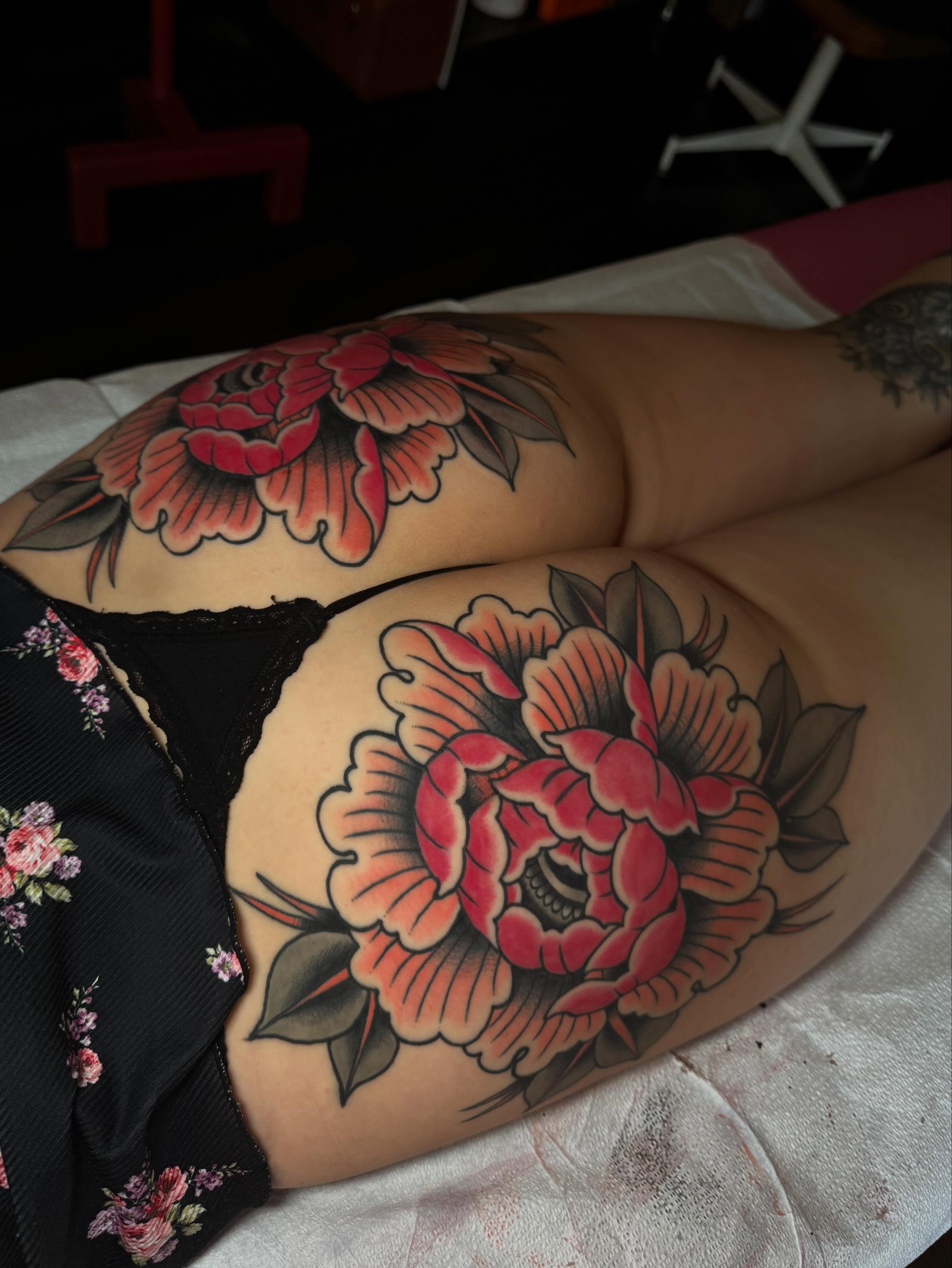 Peony flowers American traditional tattoo on the thigh by Painted Peach Tattooer