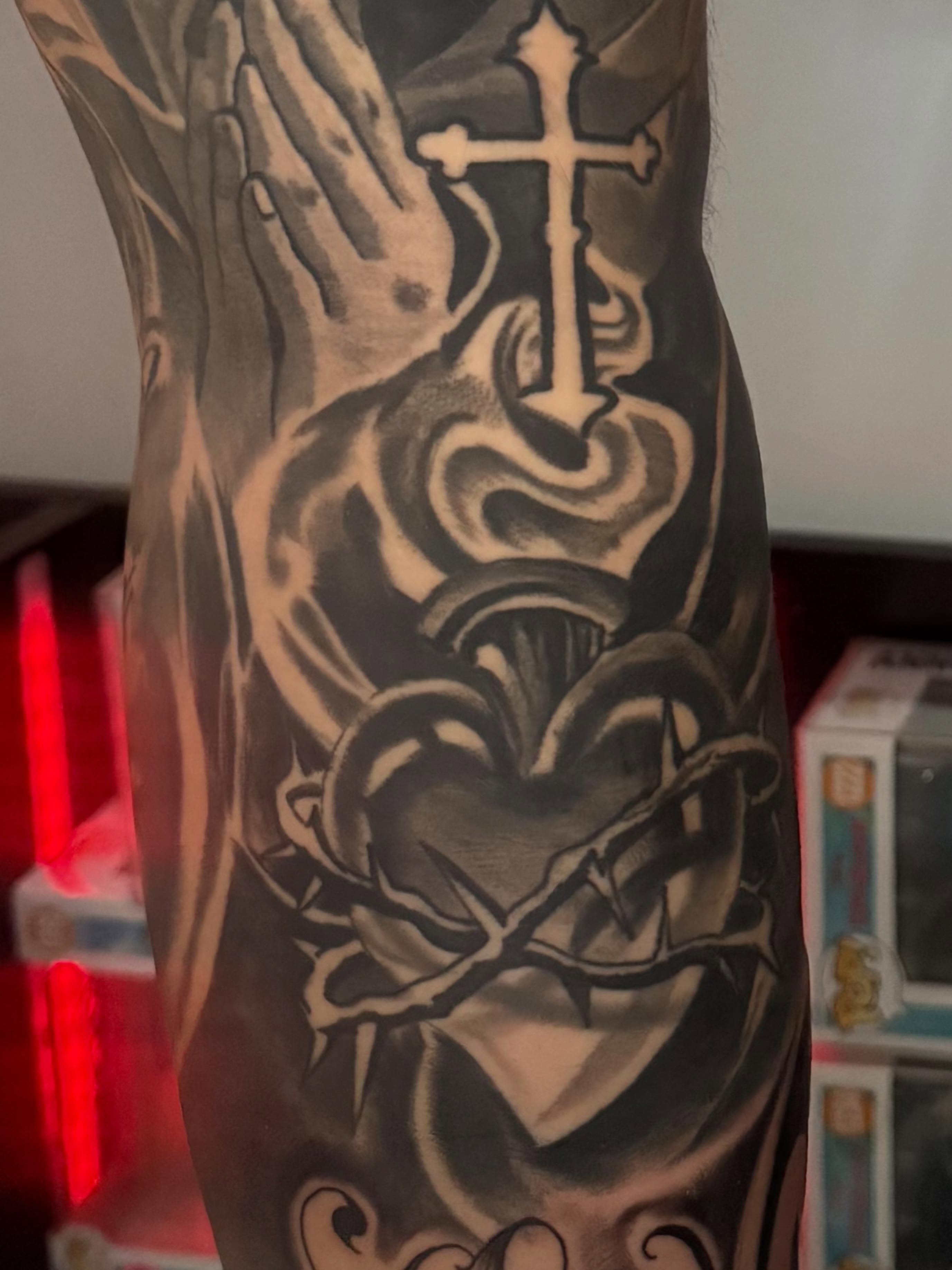Heart with crown of thorns realism tattoo on the forearm by Joseph Pacheco