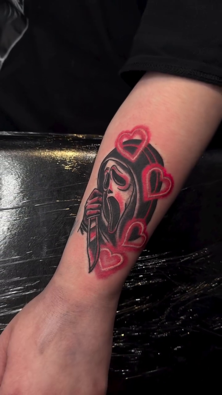 Ghostface with hearts realism tattoo on the forearm by Mercy Dean