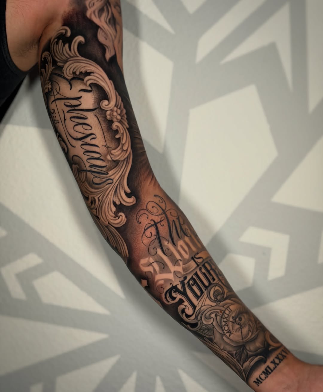 Ornate lettering and rose Chicano tattoo on the forearm by Las Vegas Tattoo Artist