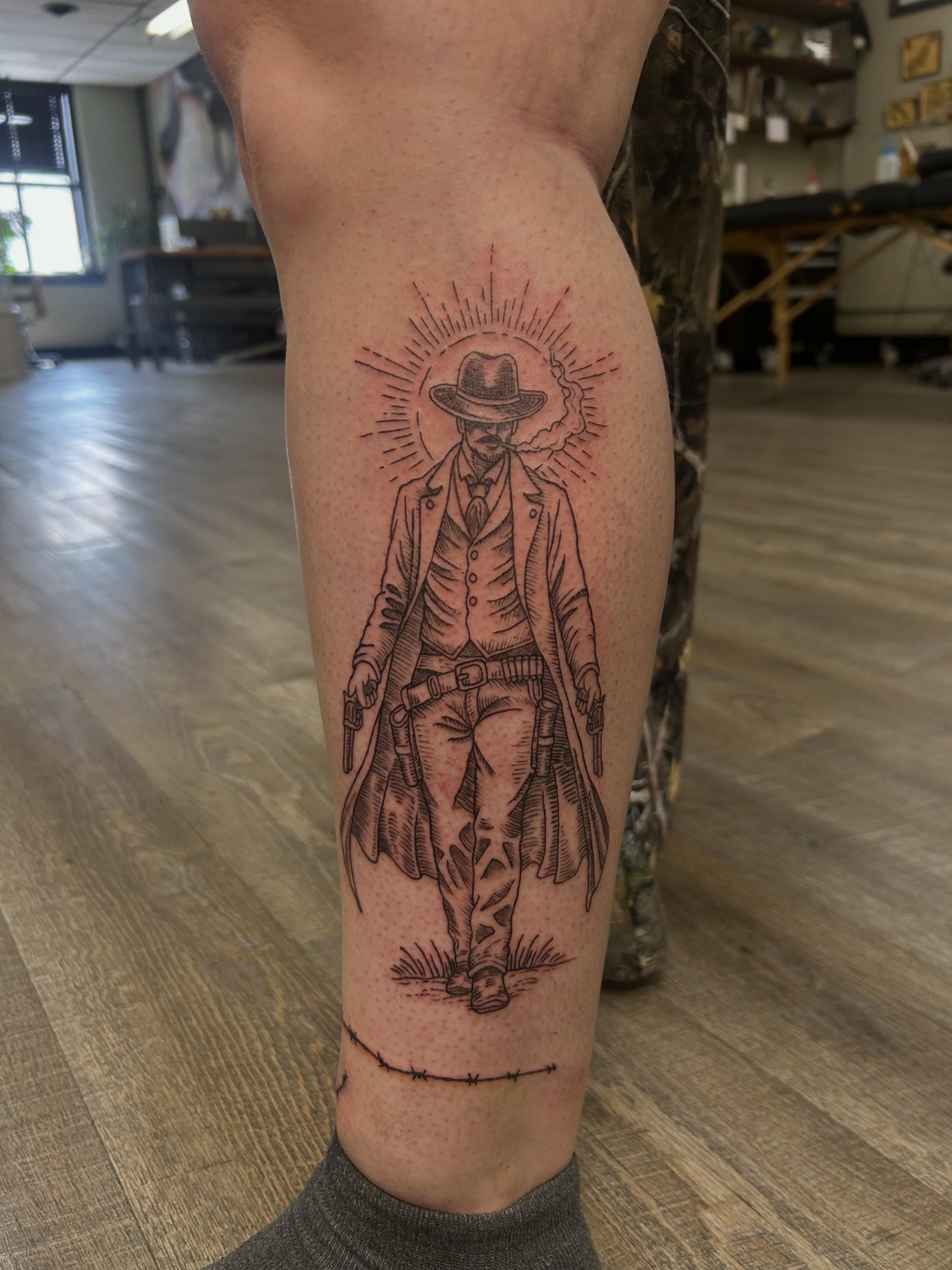 Cowboy black and grey tattoo on the leg by Kaylee