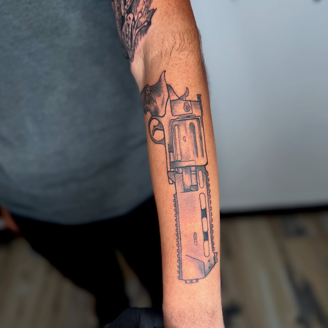 Revolver gun anime tattoo on the forearm by K Valentine