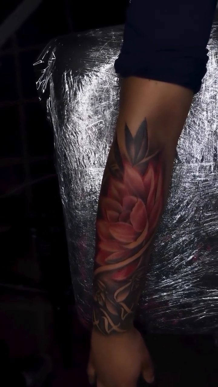 Red lotus flower sleeve neo-traditional tattoo on the forearm by Inkby_larry