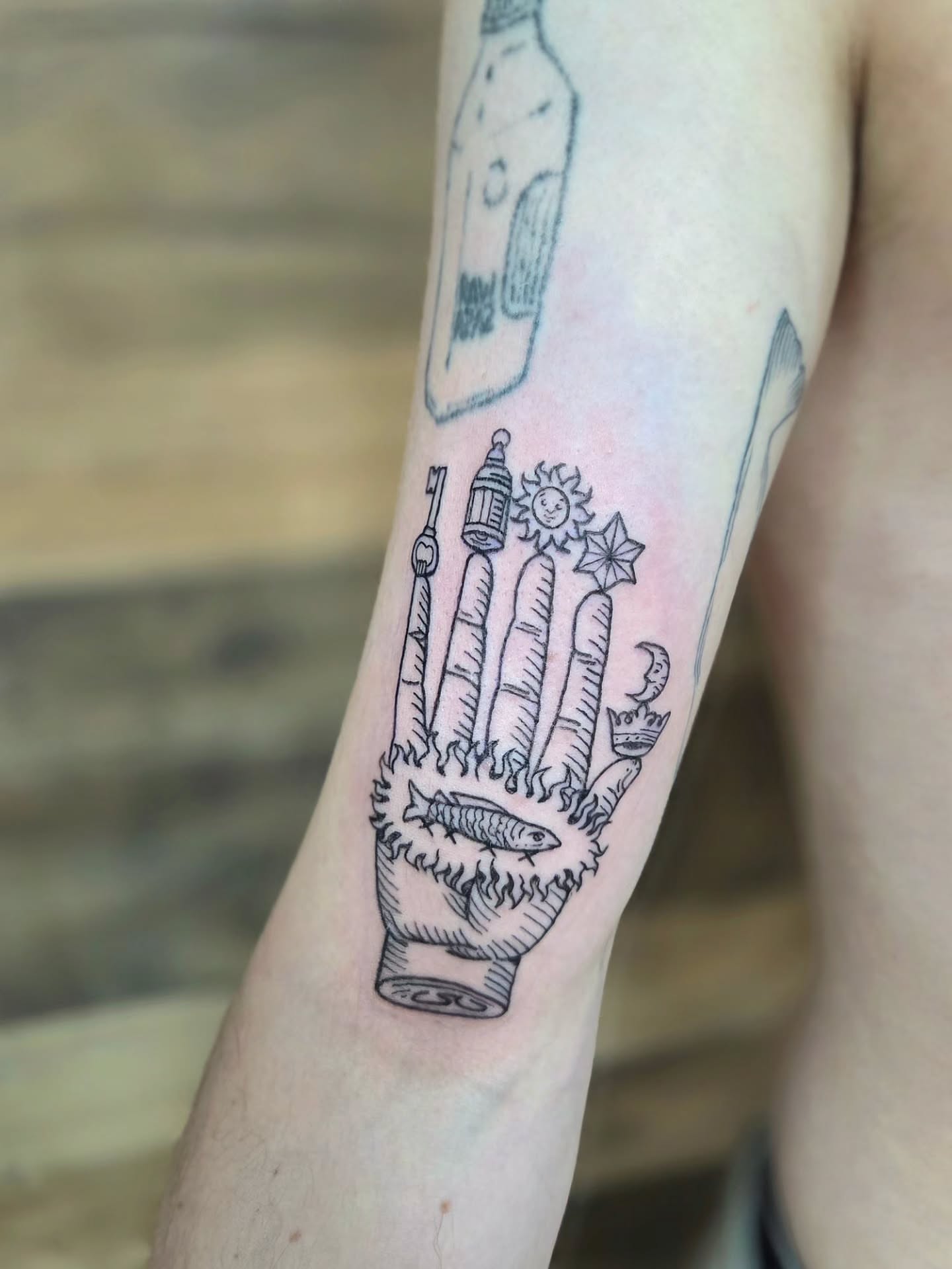 Hand with various objects black and grey tattoo on the forearm by Courtney, Lakewood, Ohio